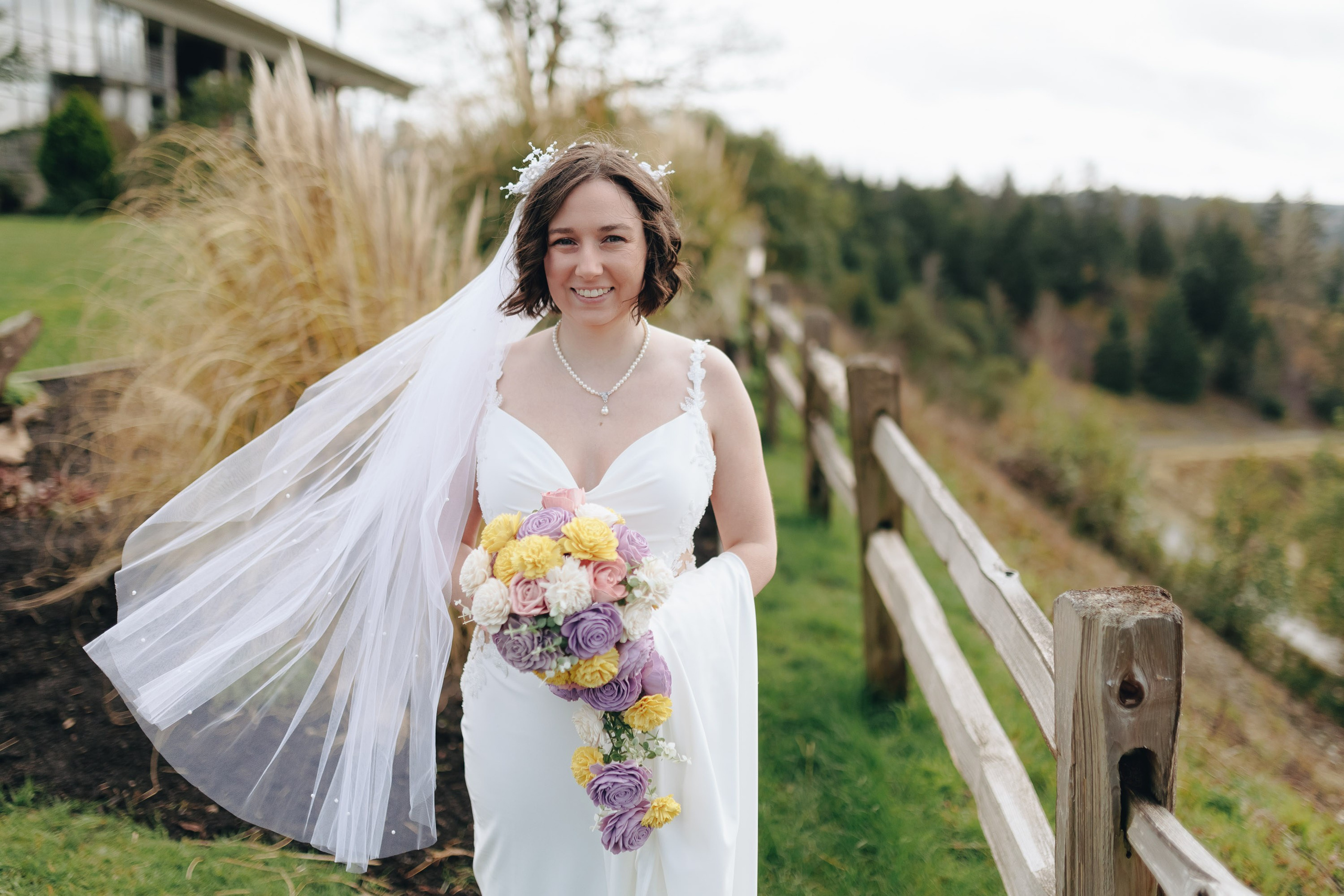 Bride with veil flowing in wind, outdoor portrait