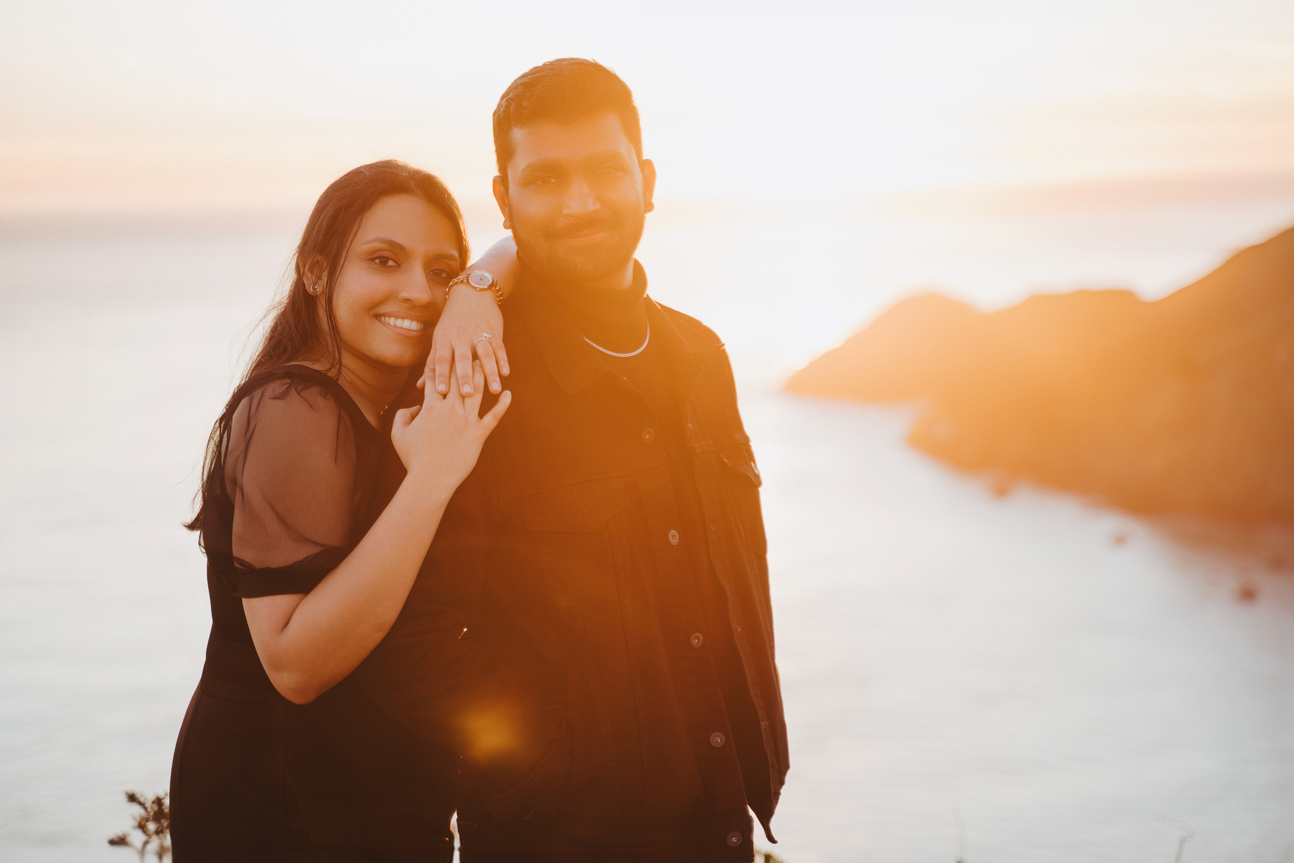 Proposal.  Overlooking the golden San Franisco Bridge sunset with a couple. Photographer Video. 