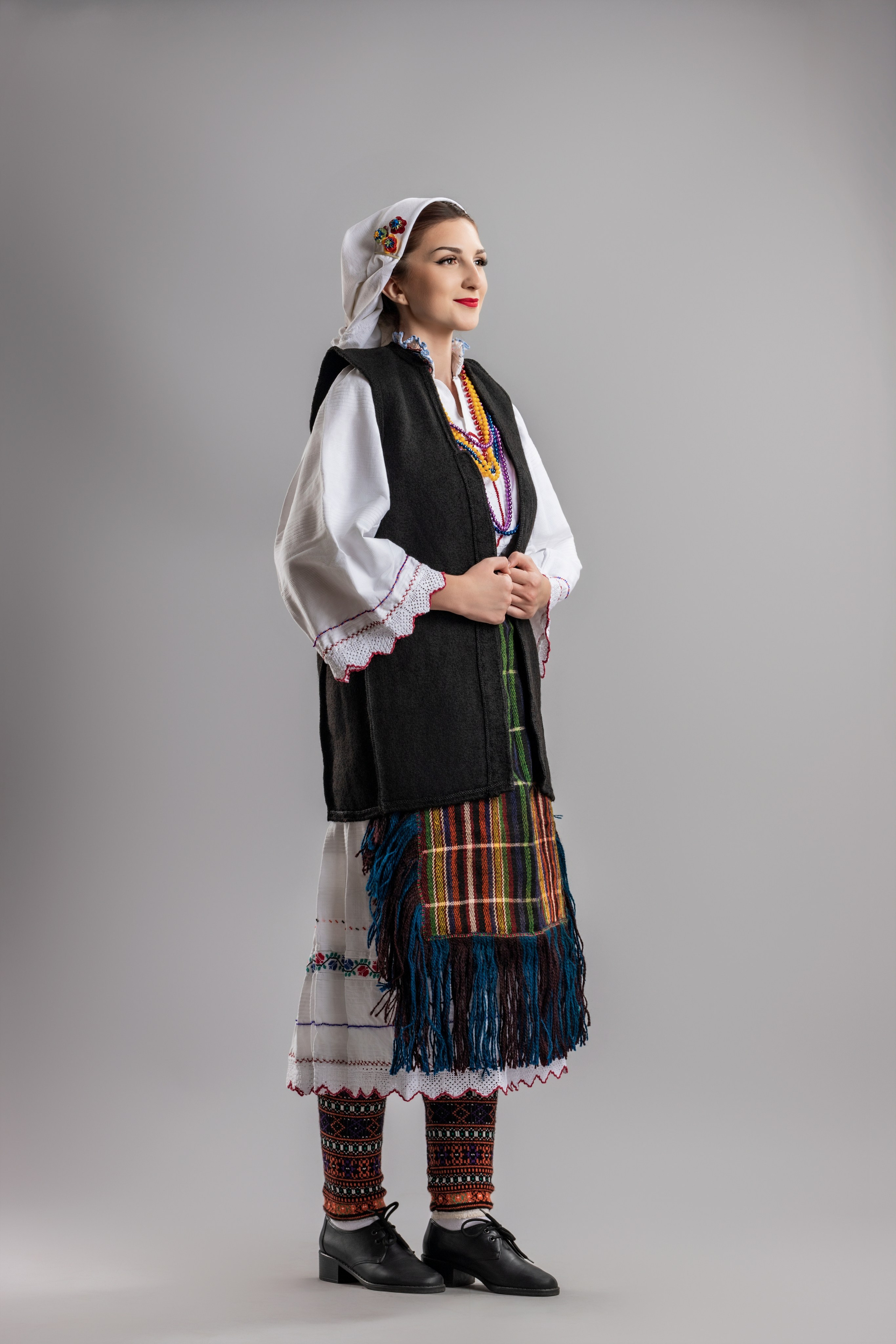 Studio portrait photography of traditional folk costumes from Bosnia and Herzegovina featuring authentic cultural clothing, embroidery, jewelry and handcrafted garments, photographed by Namir Čomaga. The images highlight the richness, craftsmanship and cultural heritage of Bosnian traditional costumes through carefully lit studio portraits.