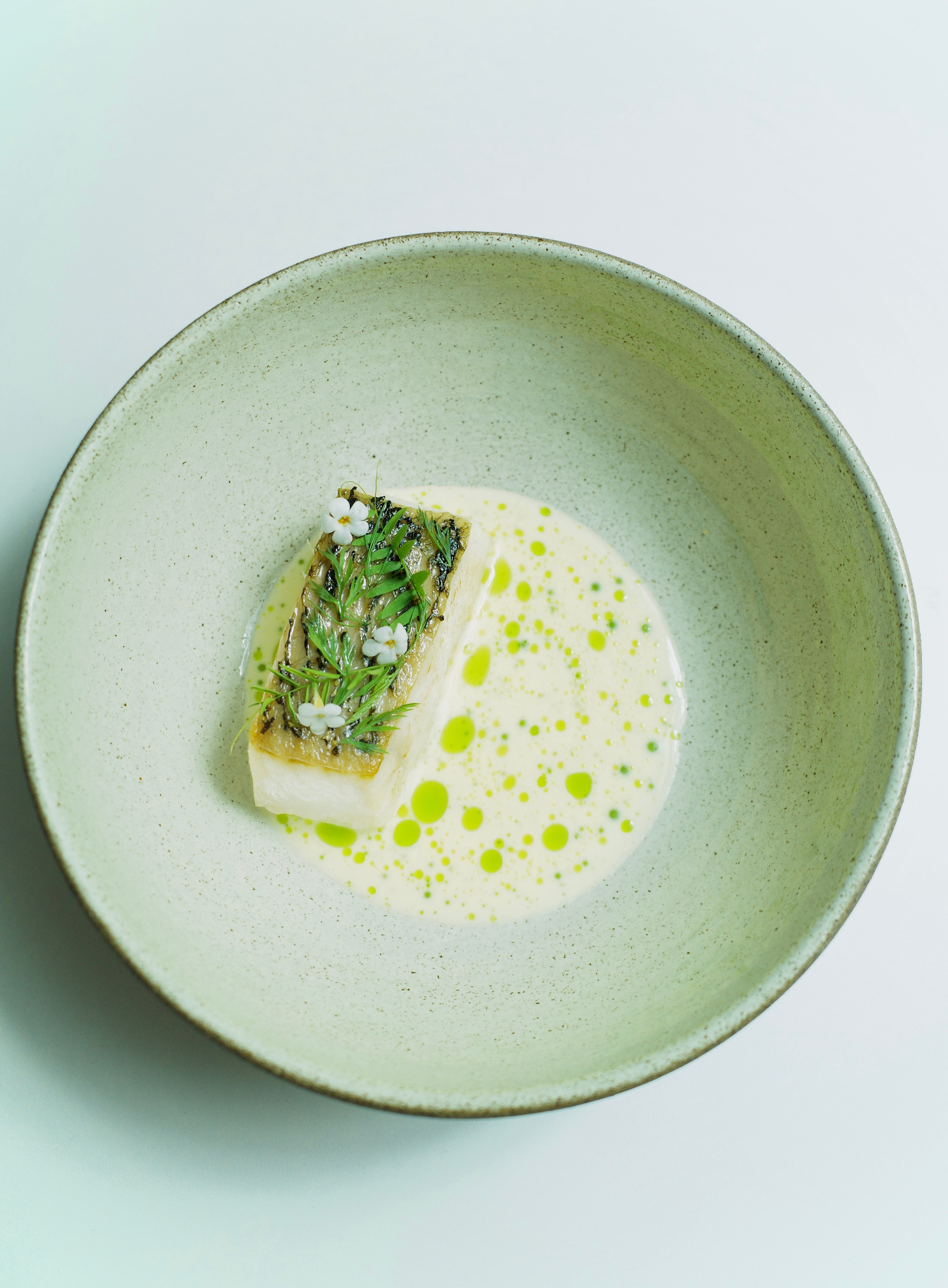 Local white fish, beurre blanc, aromatic herb oil.