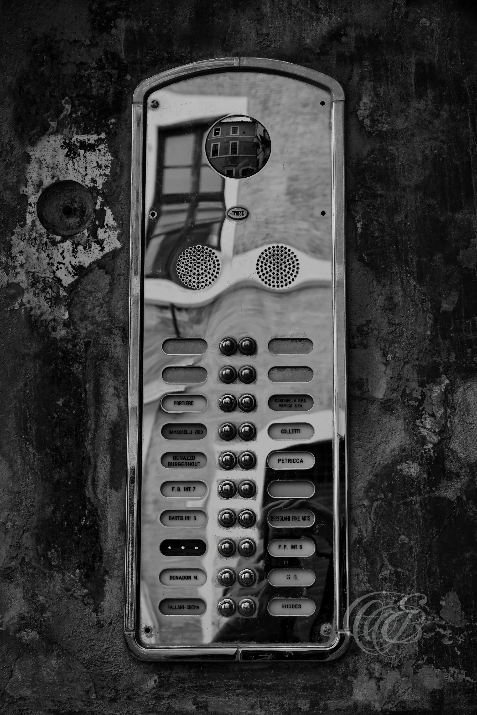 Street Photography — Rome, Italy — Golden Citofono — B&W — Black and white study of a building intercom, known in Italian as a citofono, in Rome, emphasizing architectural detail, everyday Italian life, metalwork, and urban texture — Eduardo Bartoli Photography.