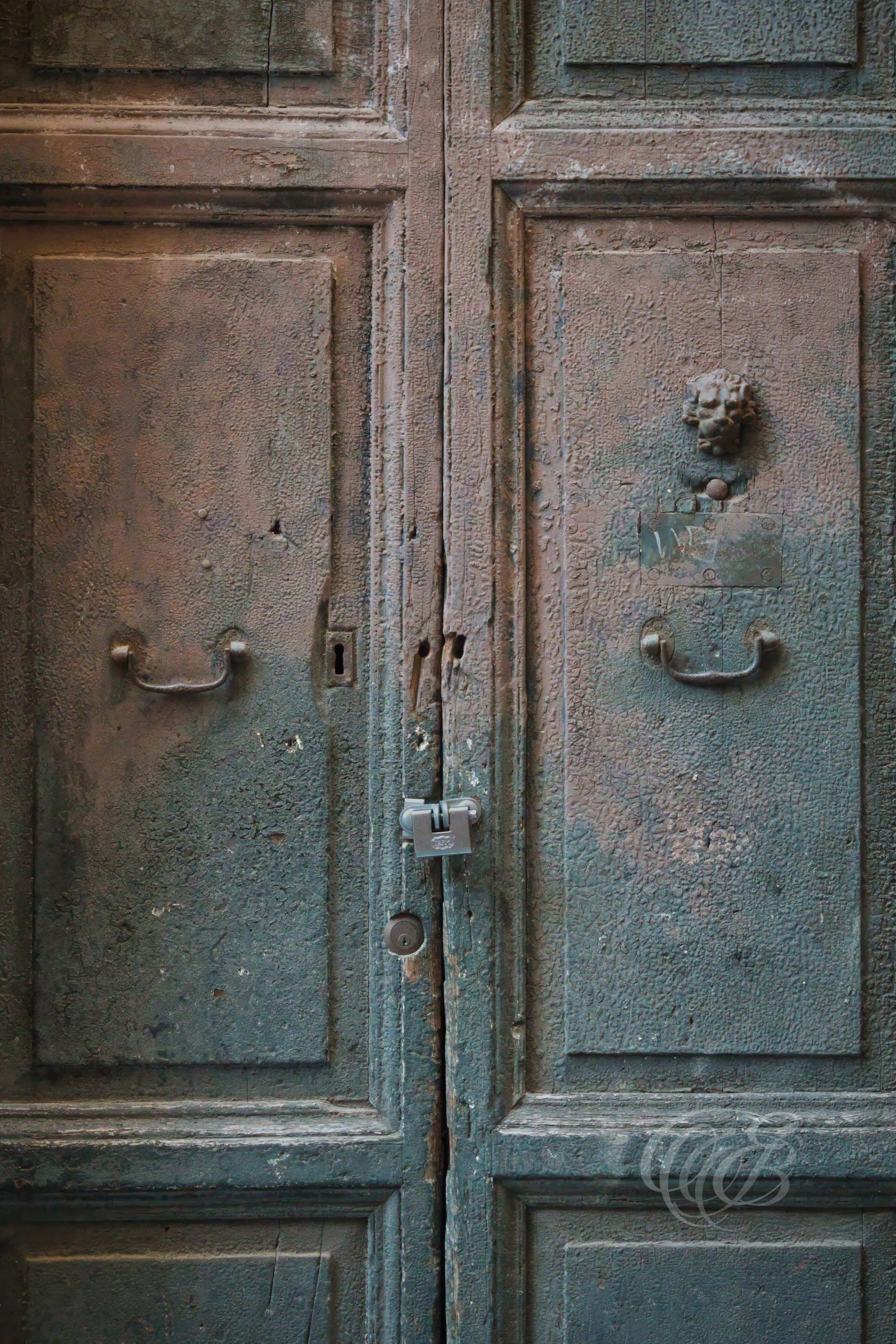 Street Photography — Rome, Italy — Old Patina Door — Weathered historic doorway in Rome with aged patina and textured surfaces, reflecting the passage of time and the enduring architectural character of the city’s streets — Eduardo Bartoli Photography.