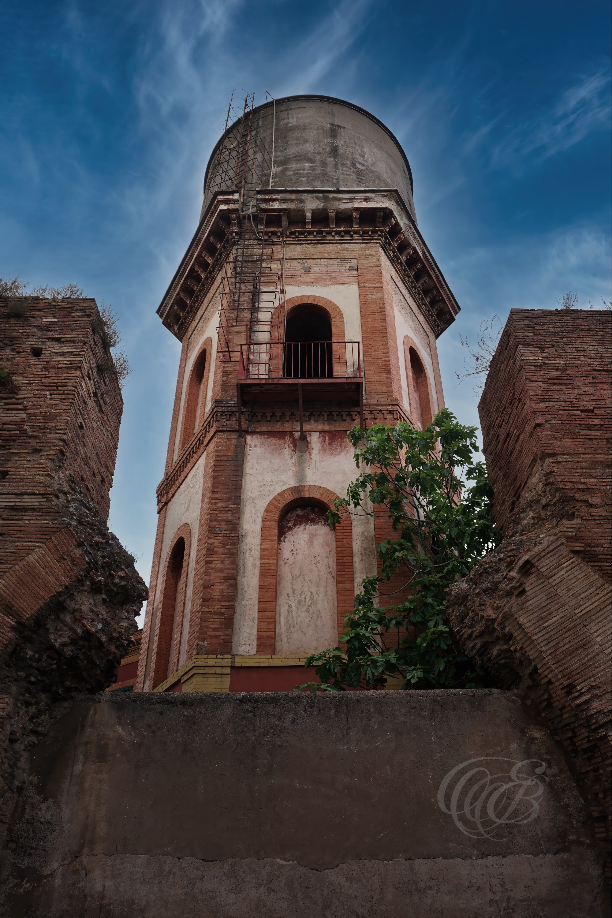 Street Photography — Rome, Italy — Water Tower — Urban view of a water tower in Rome, capturing the functional architecture and everyday infrastructure found within the city’s varied streetscape — Eduardo Bartoli Photography.