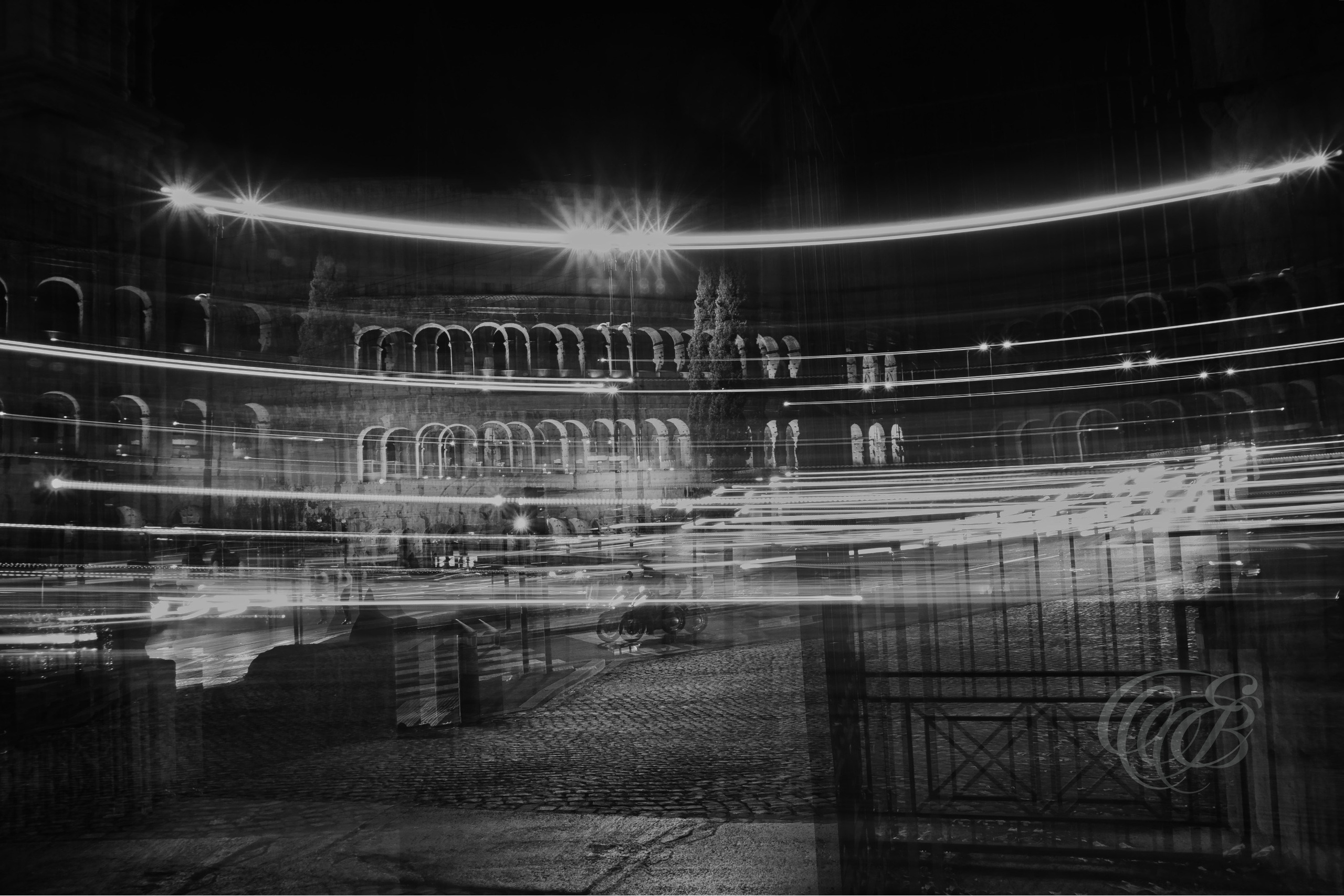 Street Photography — Rome, Italy — Moving Colosseum — B&W — Black and white long-exposure interpretation of the Colosseum, contrasting ancient Roman architecture with movement, shifting forms, and the contemporary rhythms of Rome — Eduardo Bartoli Photography.