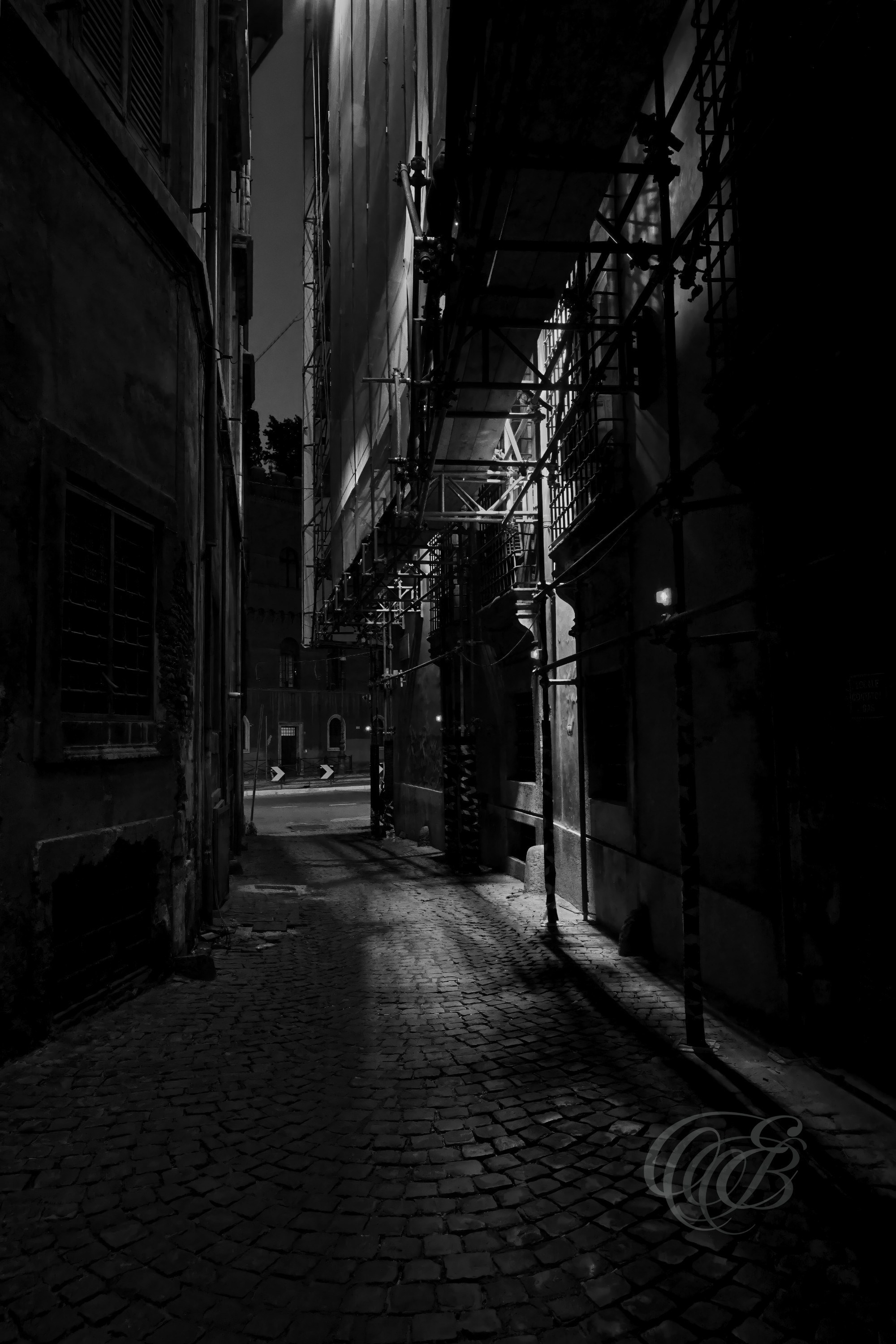 Street Photography — Rome, Italy — Vicolo degli Astalli — B&W — Black and white interpretation of historic Vicolo degli Astalli in central Rome, emphasizing its narrow proportions, aged architecture, and the enduring character of the old city — Eduardo Bartoli Photography.