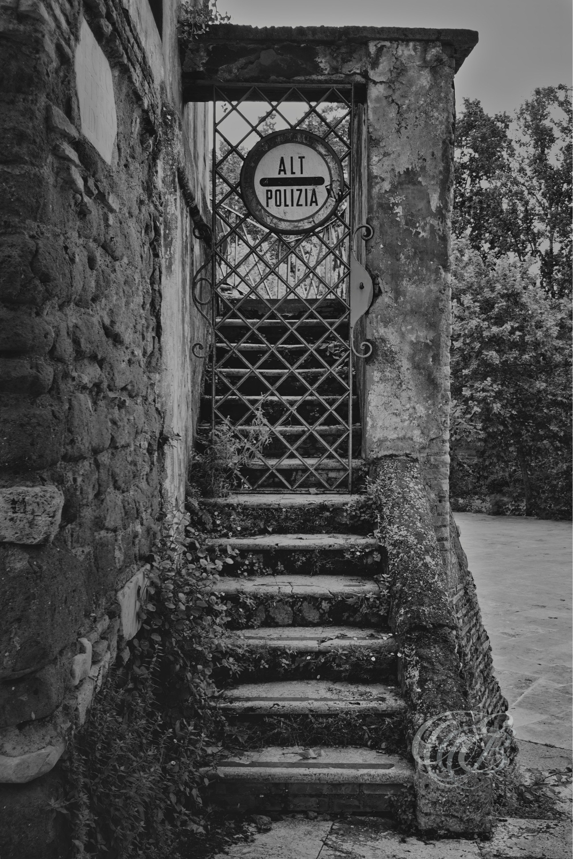 Street Photography — Rome, Italy — Tiber Island — B&W Matte — Matte black and white interpretation of historic Tiber Island, emphasizing its ancient heritage, connection with medicine and healing, tonal textures, and enduring place within the Tiber River — Eduardo Bartoli Photography.