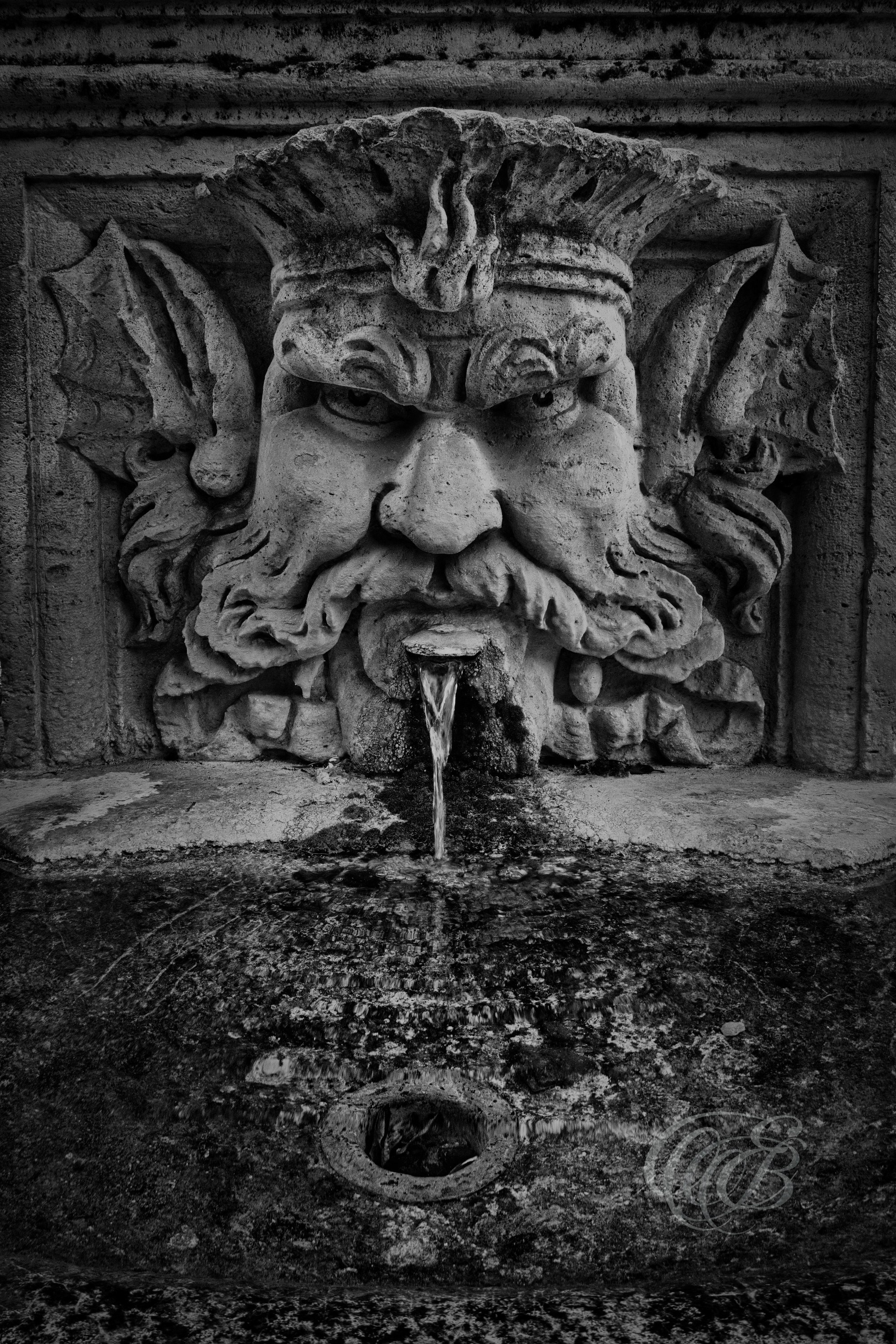 Street Photography — Rome, Italy — Drinking Fountain in Villa Borghese — B&W — Black and white view of a public drinking fountain in Rome’s Villa Borghese, reflecting the city’s historic water tradition and the everyday details found throughout its celebrated gardens — Eduardo Bartoli Photography.