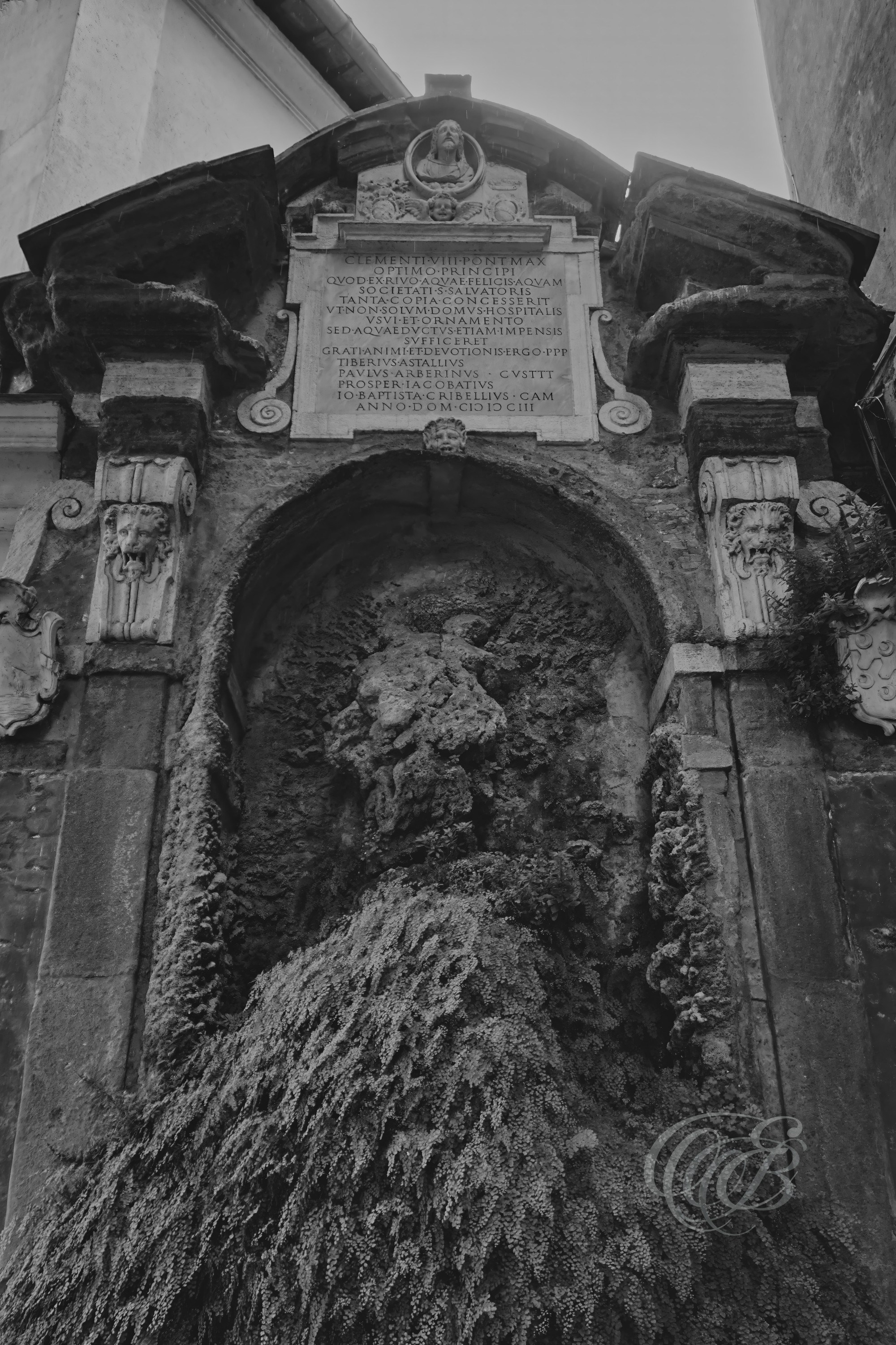 Street Photography — Rome, Italy — San Giovanni Hospital Fountain — B&W Matte — Matte black and white interpretation of a fountain within Rome’s historic San Giovanni hospital complex, emphasizing architectural form, water, tonal contrasts, and the centuries-old character of the Lateran area — Eduardo Bartoli Photography.