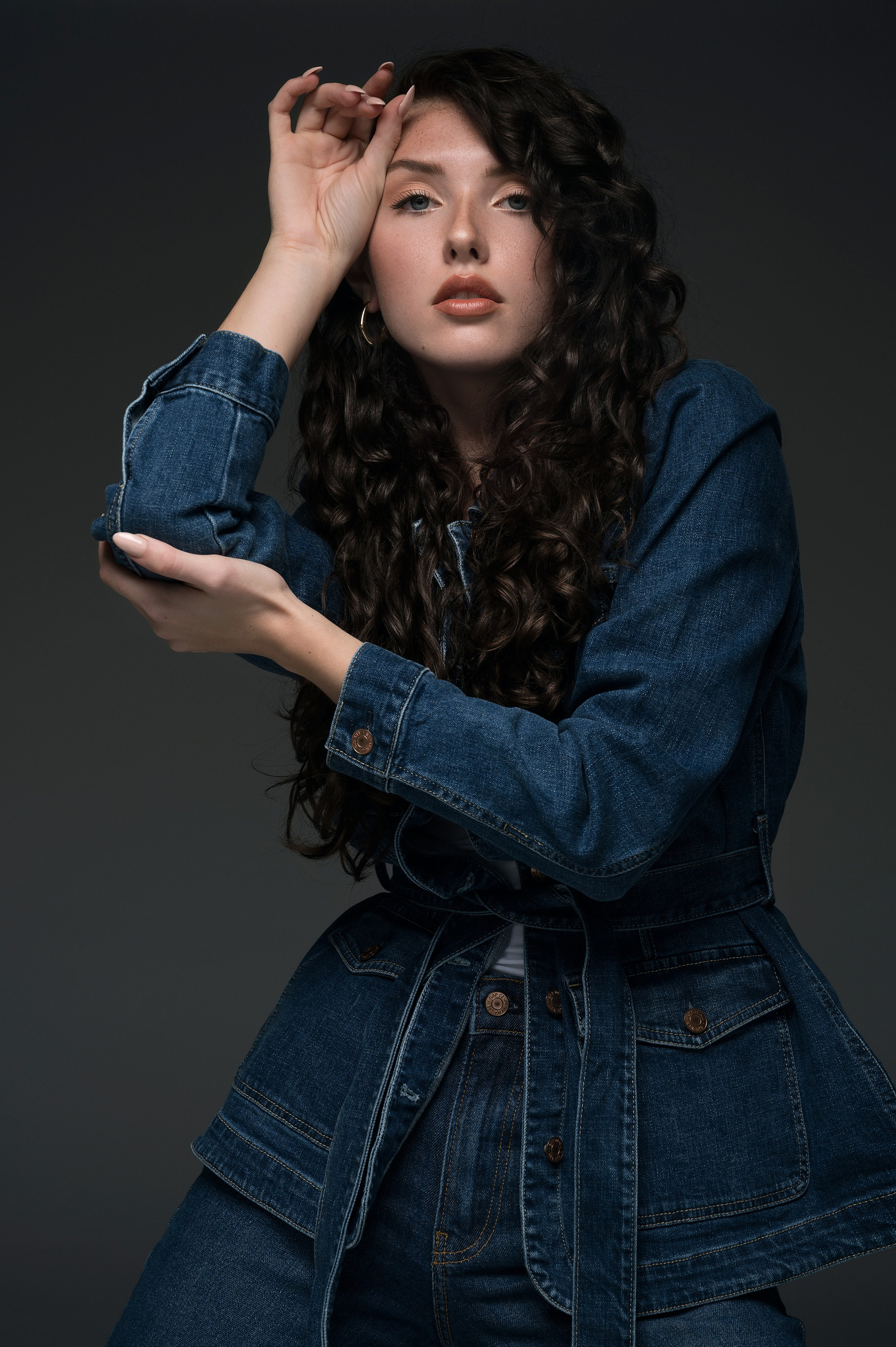 Elegant female fashion portrait in studio, with professional retouching for model portfolio.