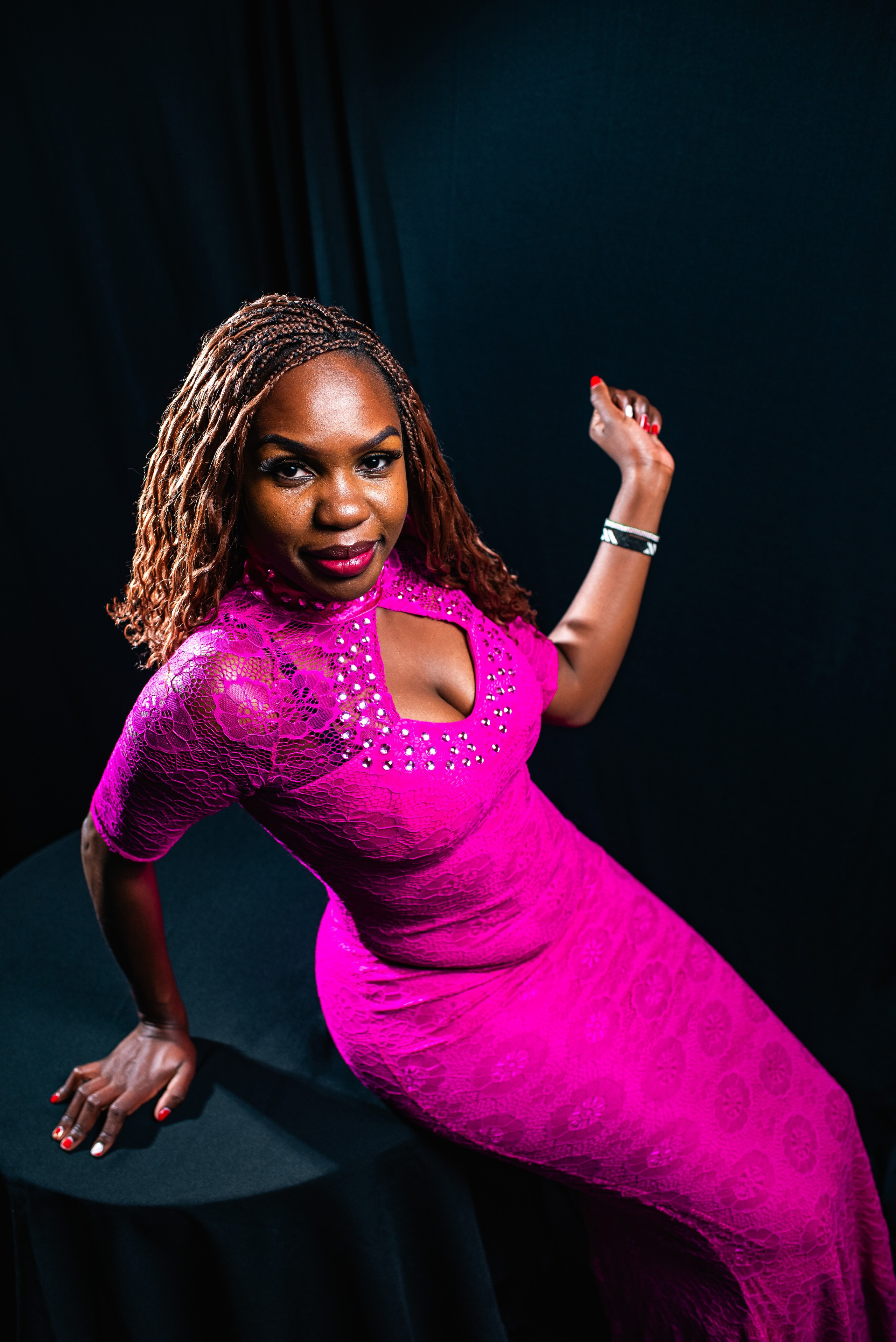 High angle portrait of a woman dressed in a hot pink dress. Photography by Nick Ouma photography