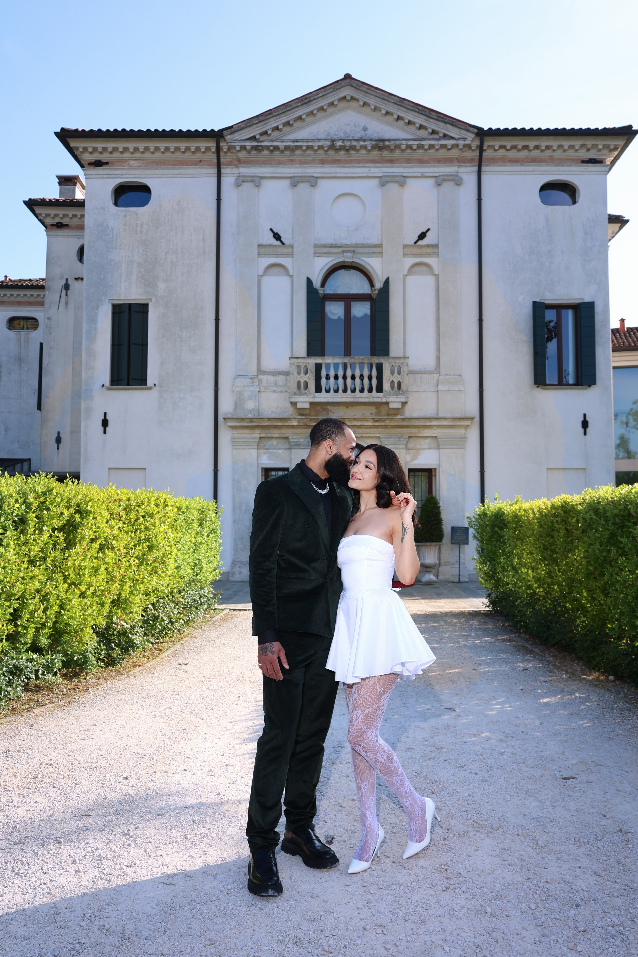 Bride and groom embracing at sunset in an Italian villa