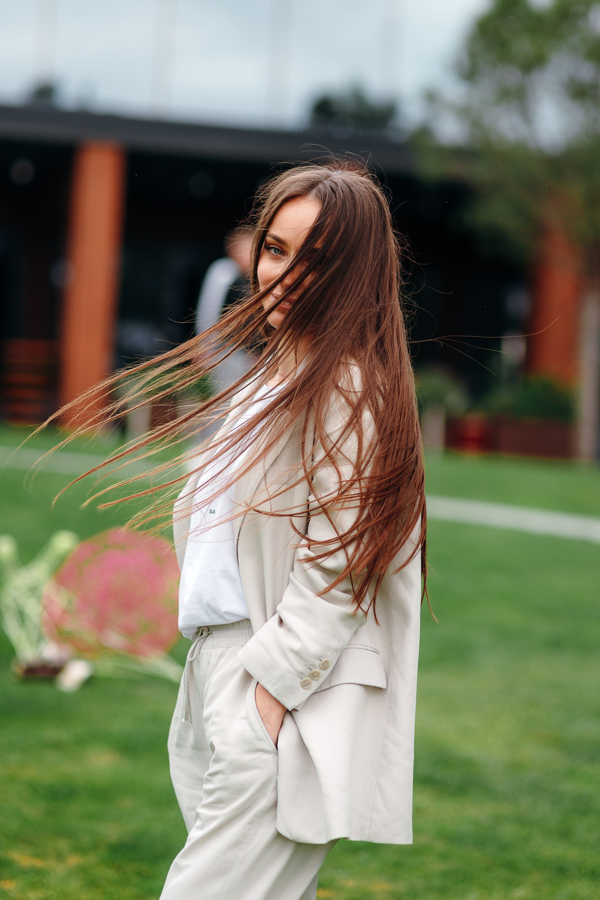 Woman with long hair smiling outdoors