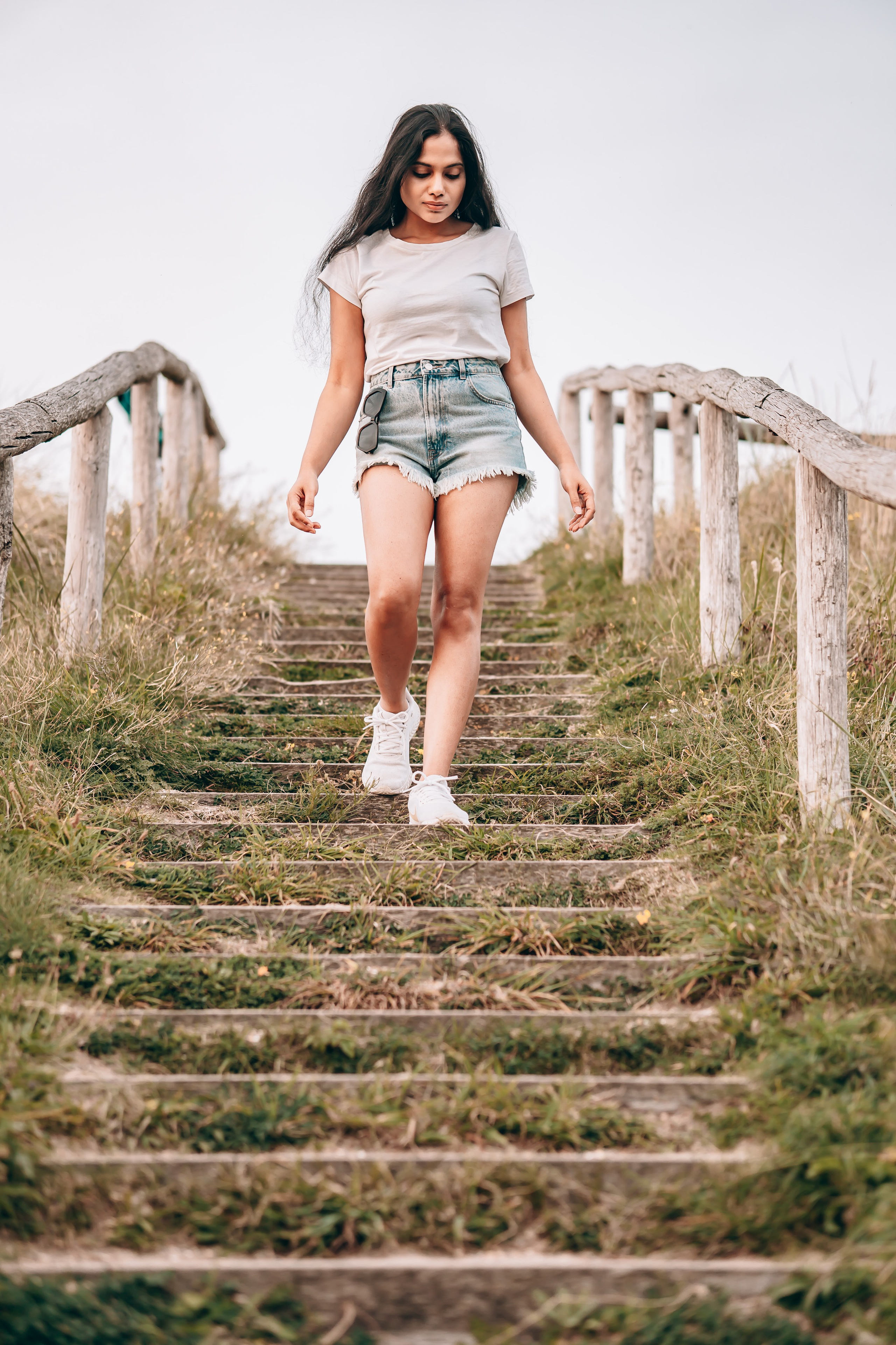 Woman walking down stairs close to the beach