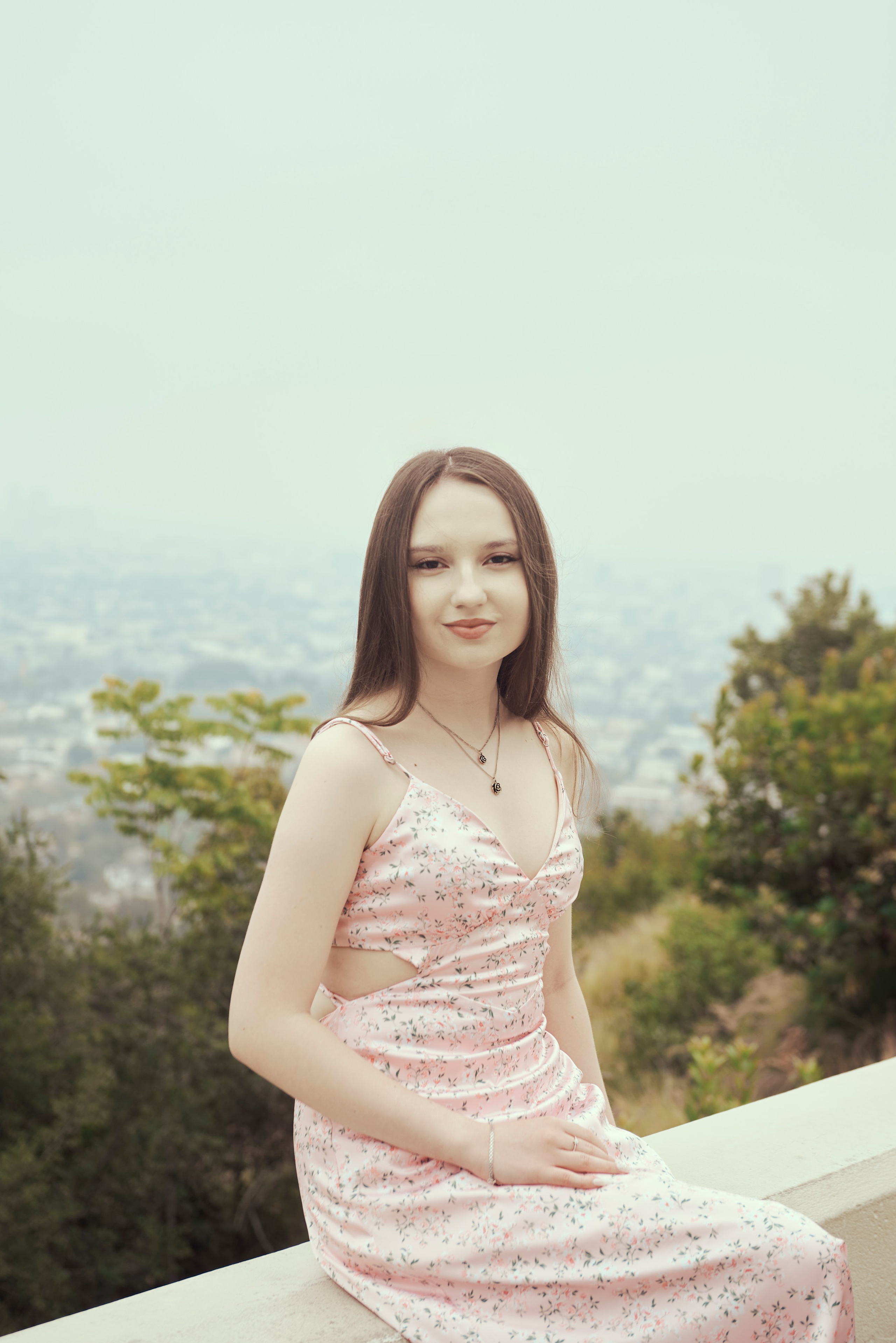 Beautiful graduation portrait of a student with the Los Angeles skyline at sunset