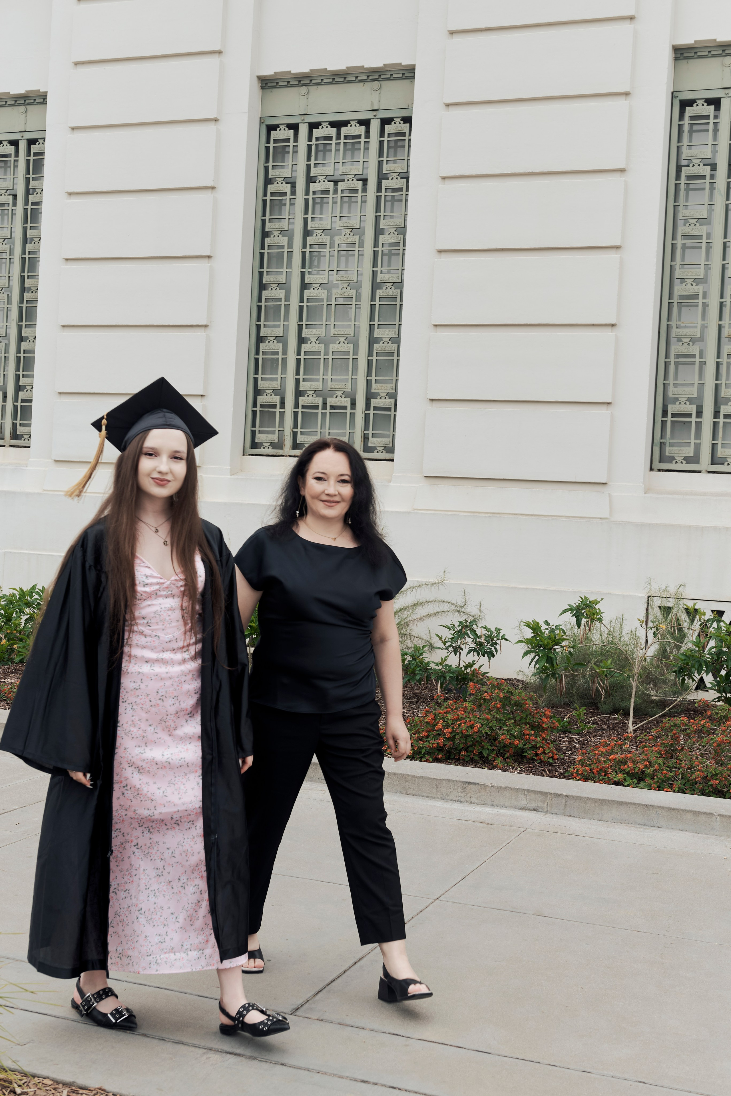 Graduate taking a thoughtful moment at a historic Los Angeles landmark