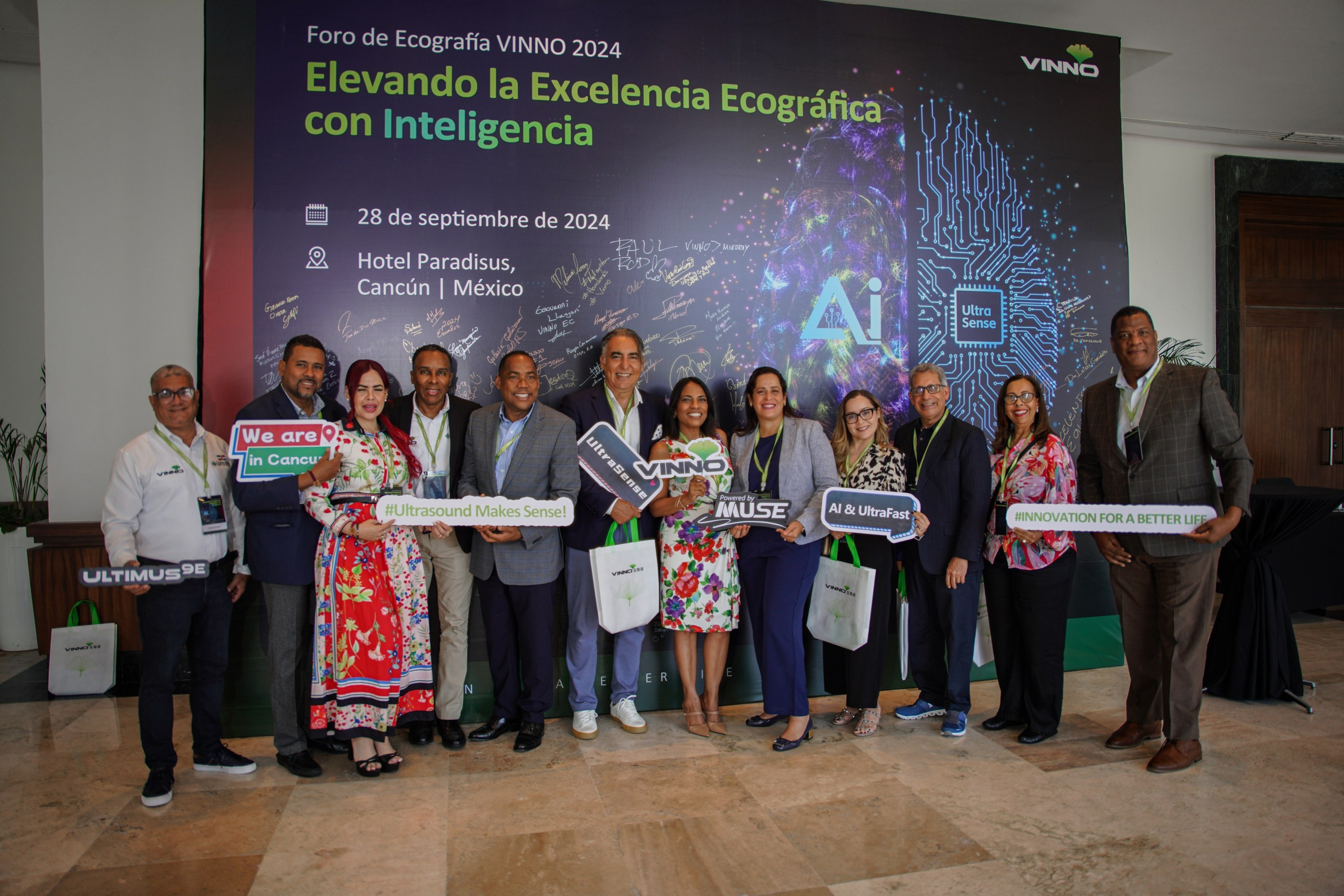 Team members and guests posing for a full-group corporate event picture.