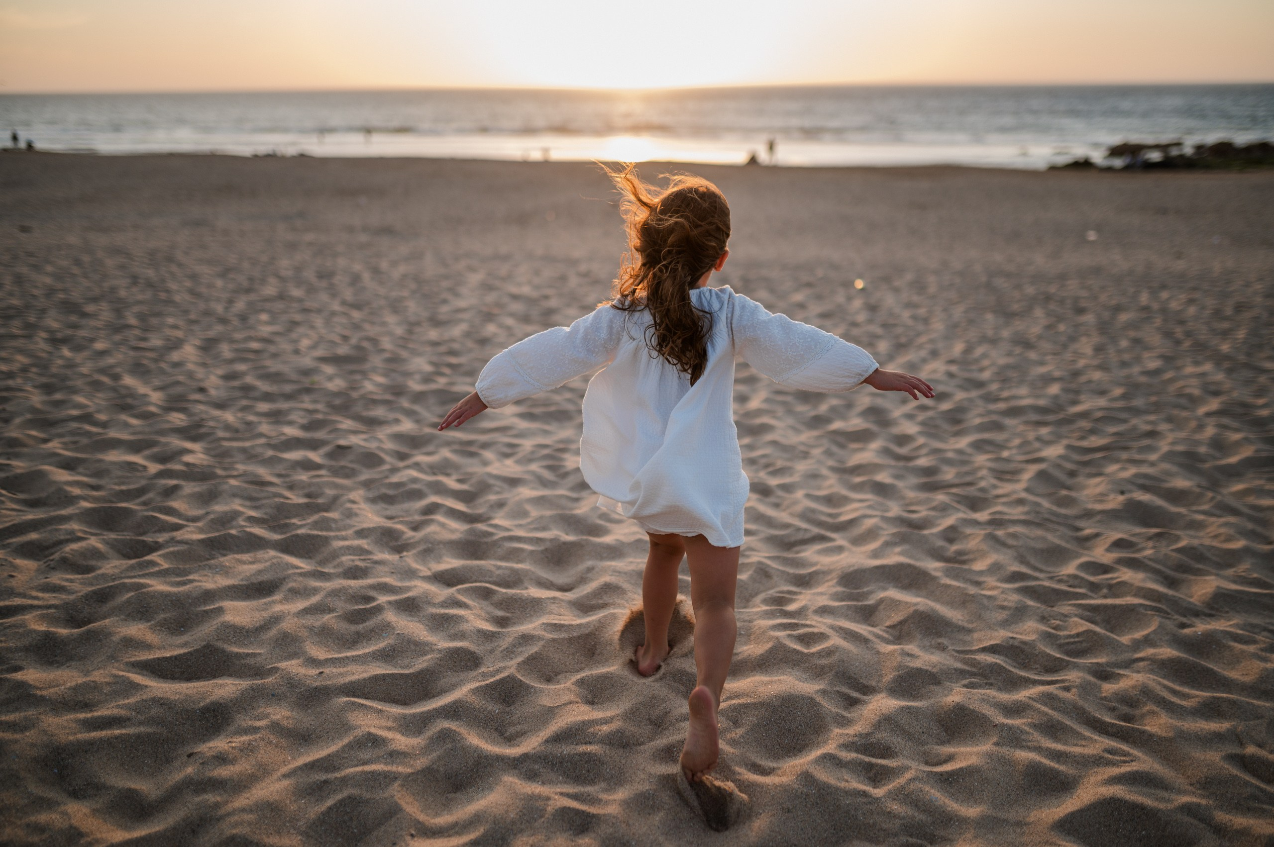 Family photo shoot for mum and daughter on Guincho beach, Portugal