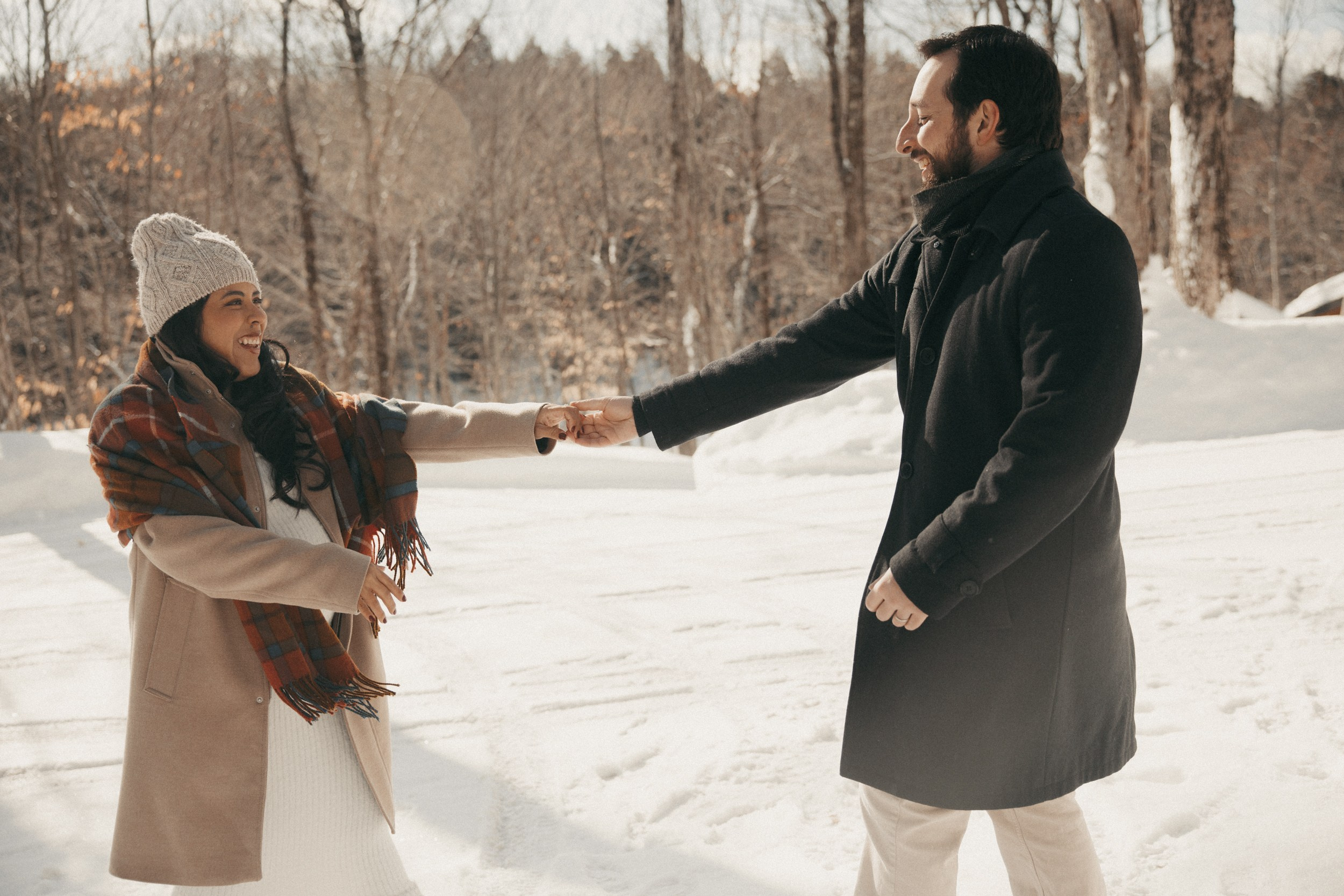 Couple walking together in snowy forest near Montreal