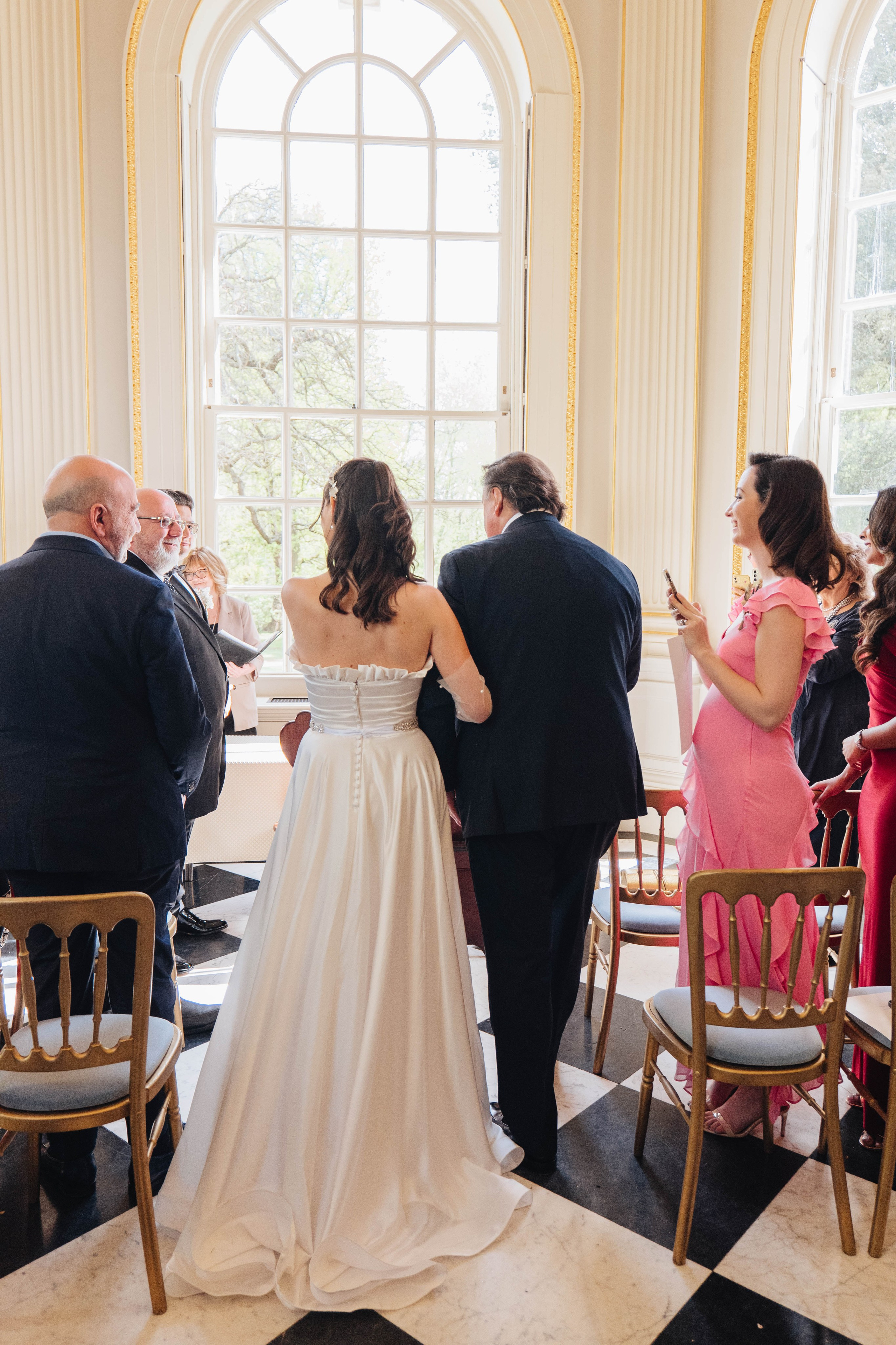 bride arriving through doors at the venue with her father