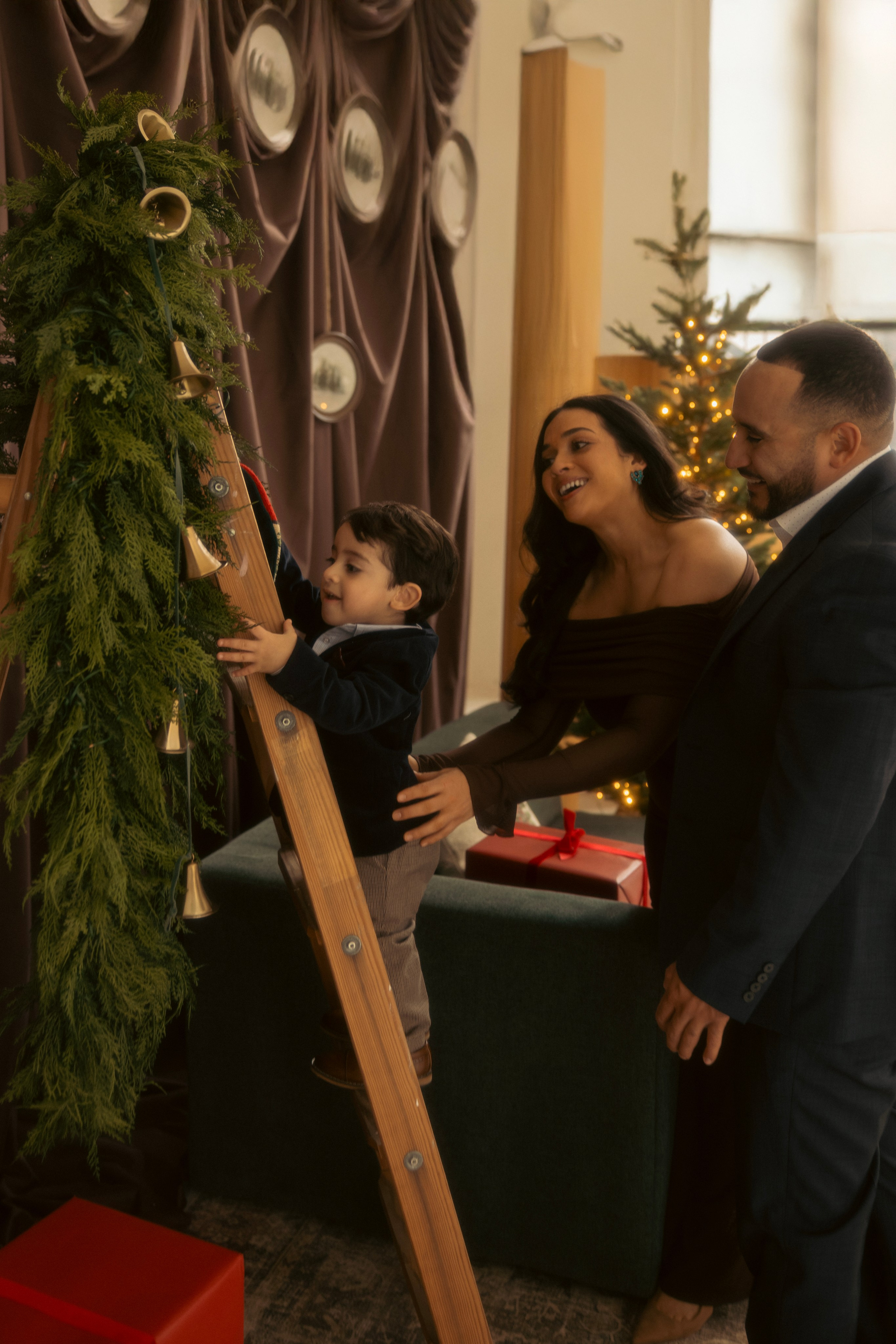 Mom and child reading near Christmas tree during holiday session