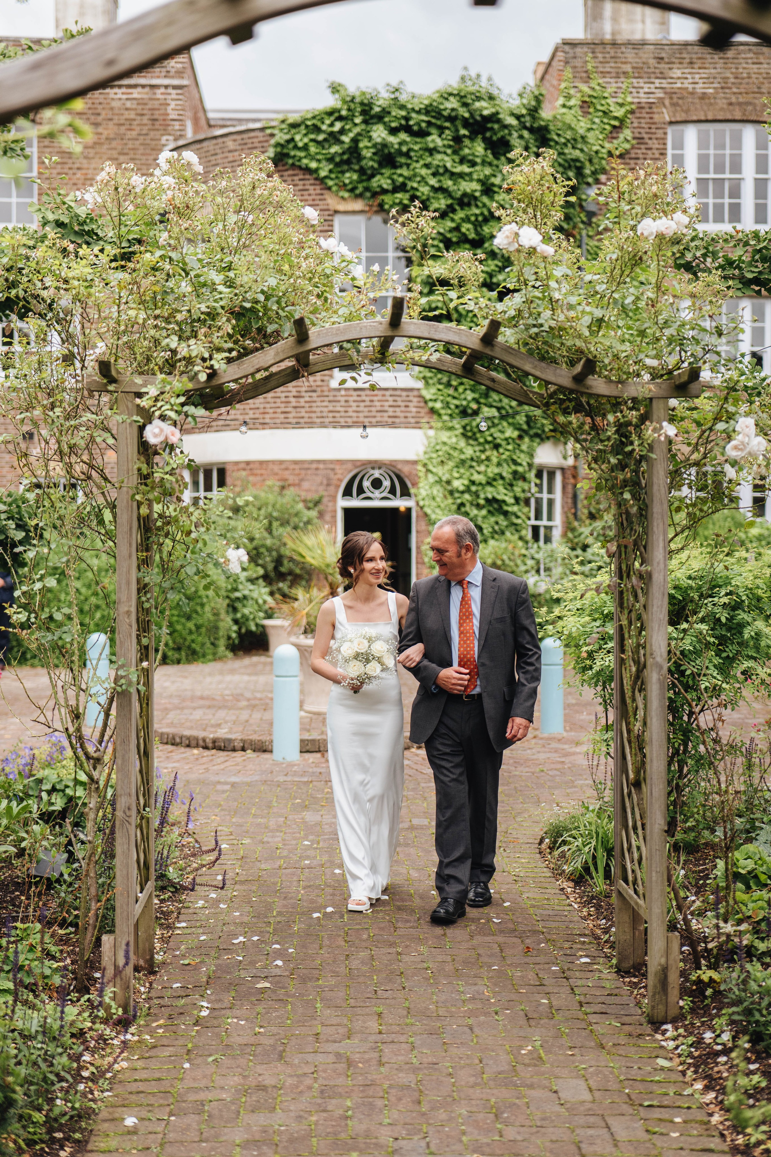 bride walking through the venue with her father