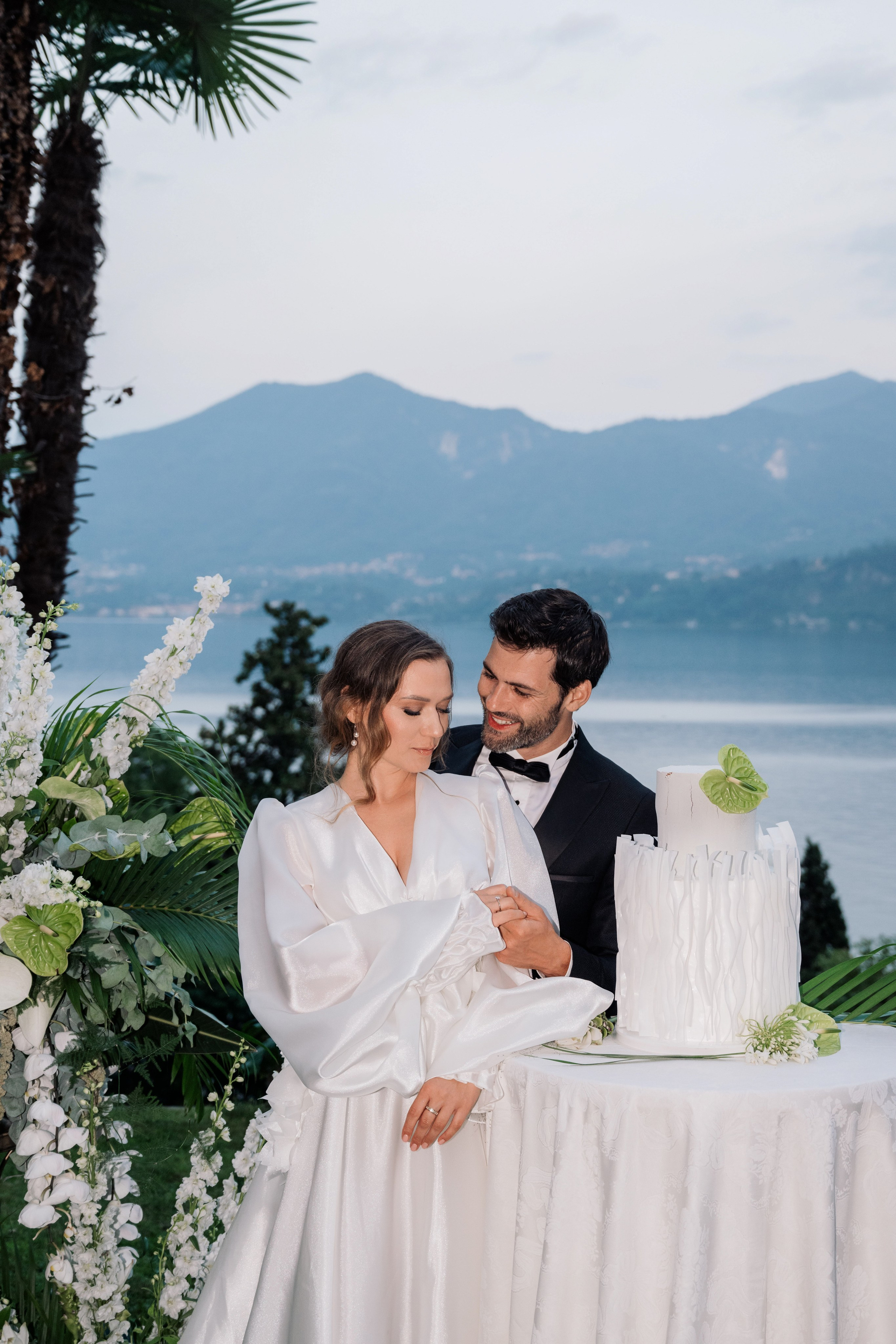 a bride and groom cutting their wedding cake