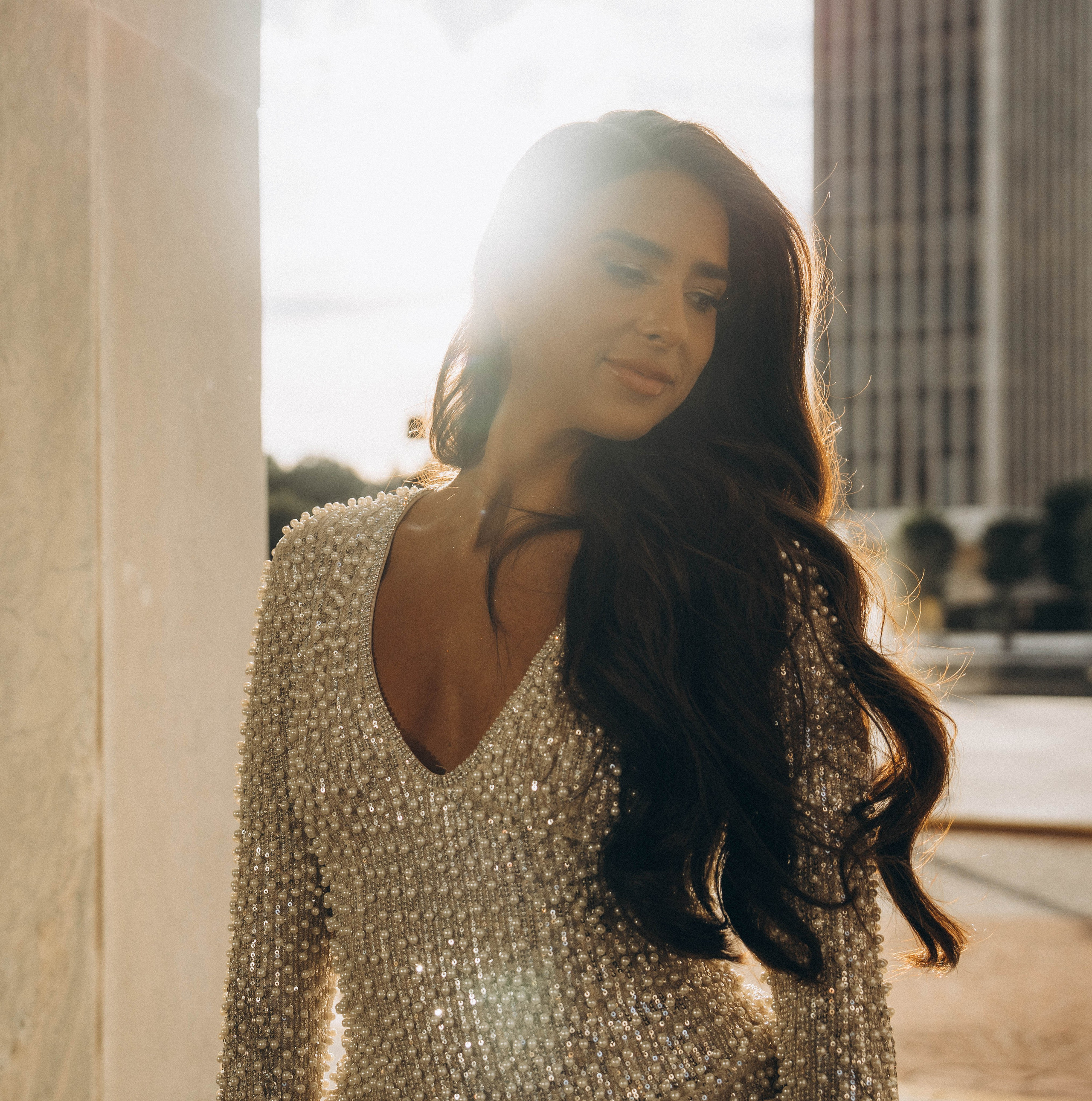 Bride smiling in front of Lake George boathouse.