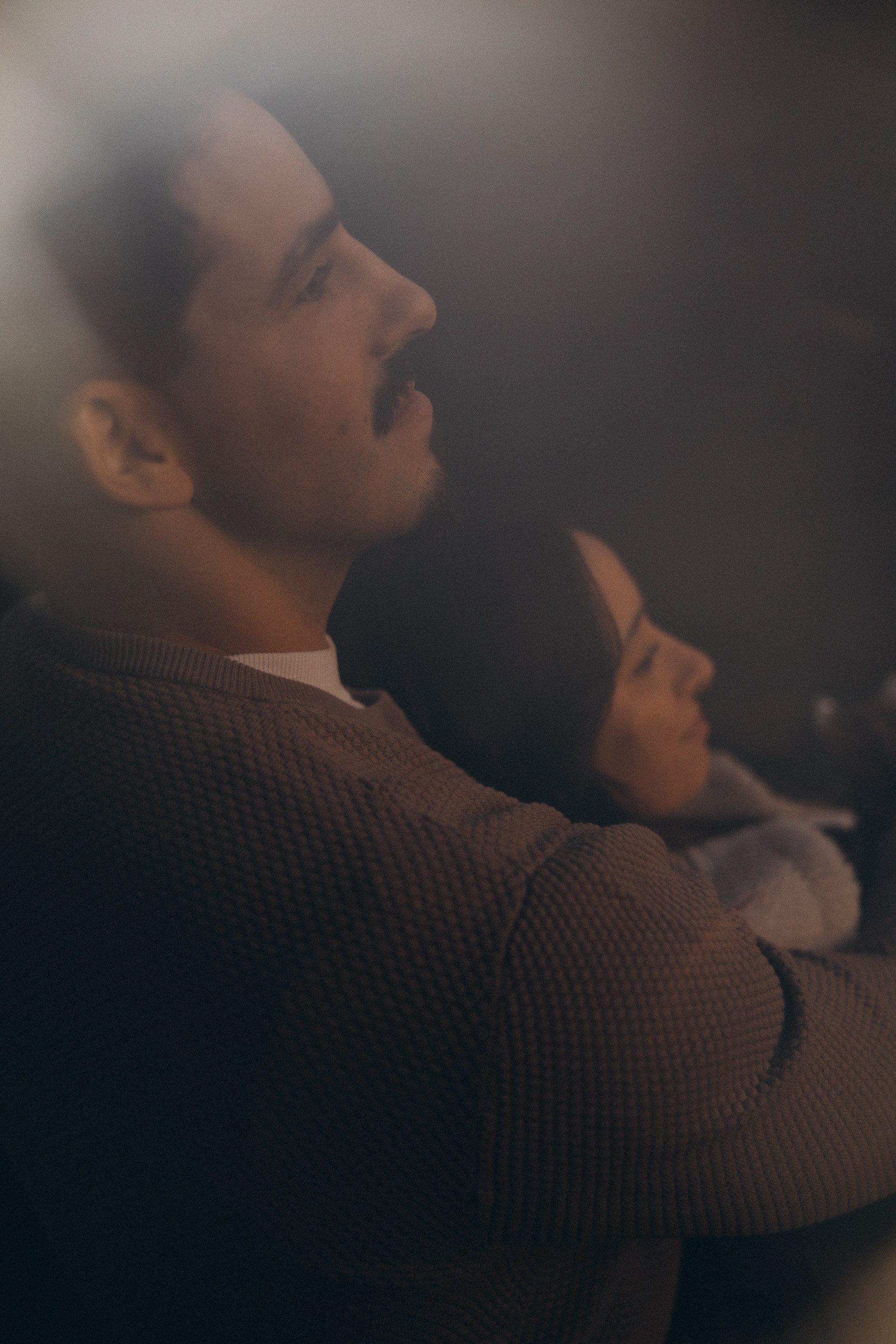 Couple sharing a romantic moment during sunset on Madeira Island, with the ocean and cliffs in the background