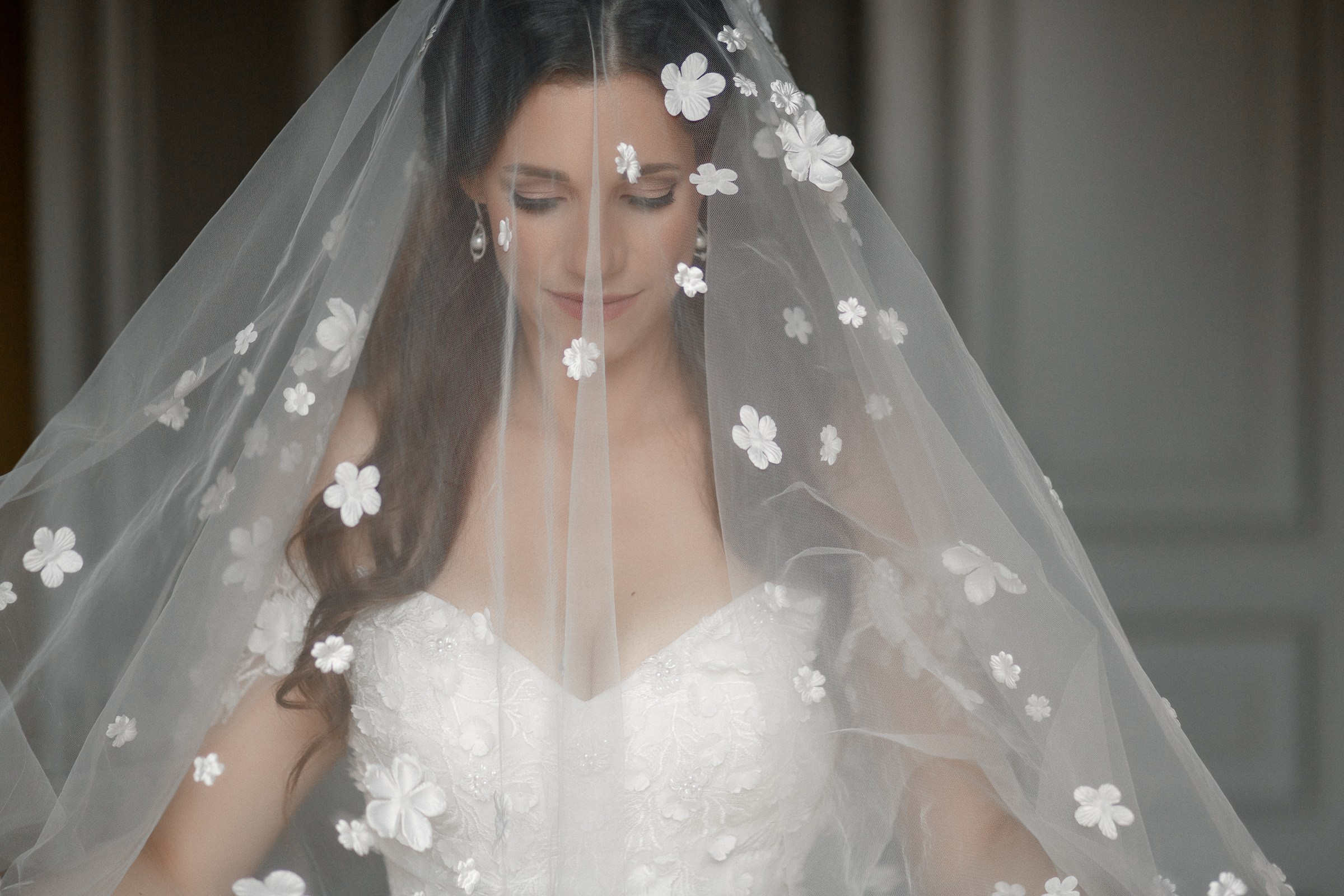 Bride in veil, by Cornwall reportage photographer.