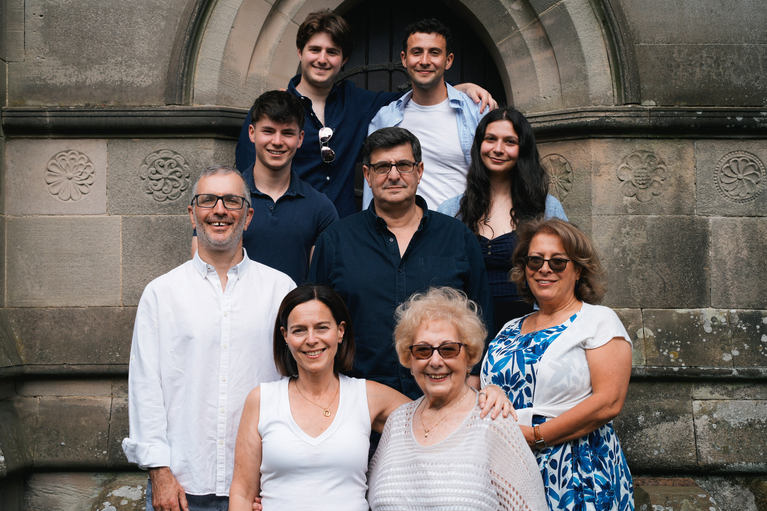 Candid outdoor photo of family celebrating 90th birthday together.