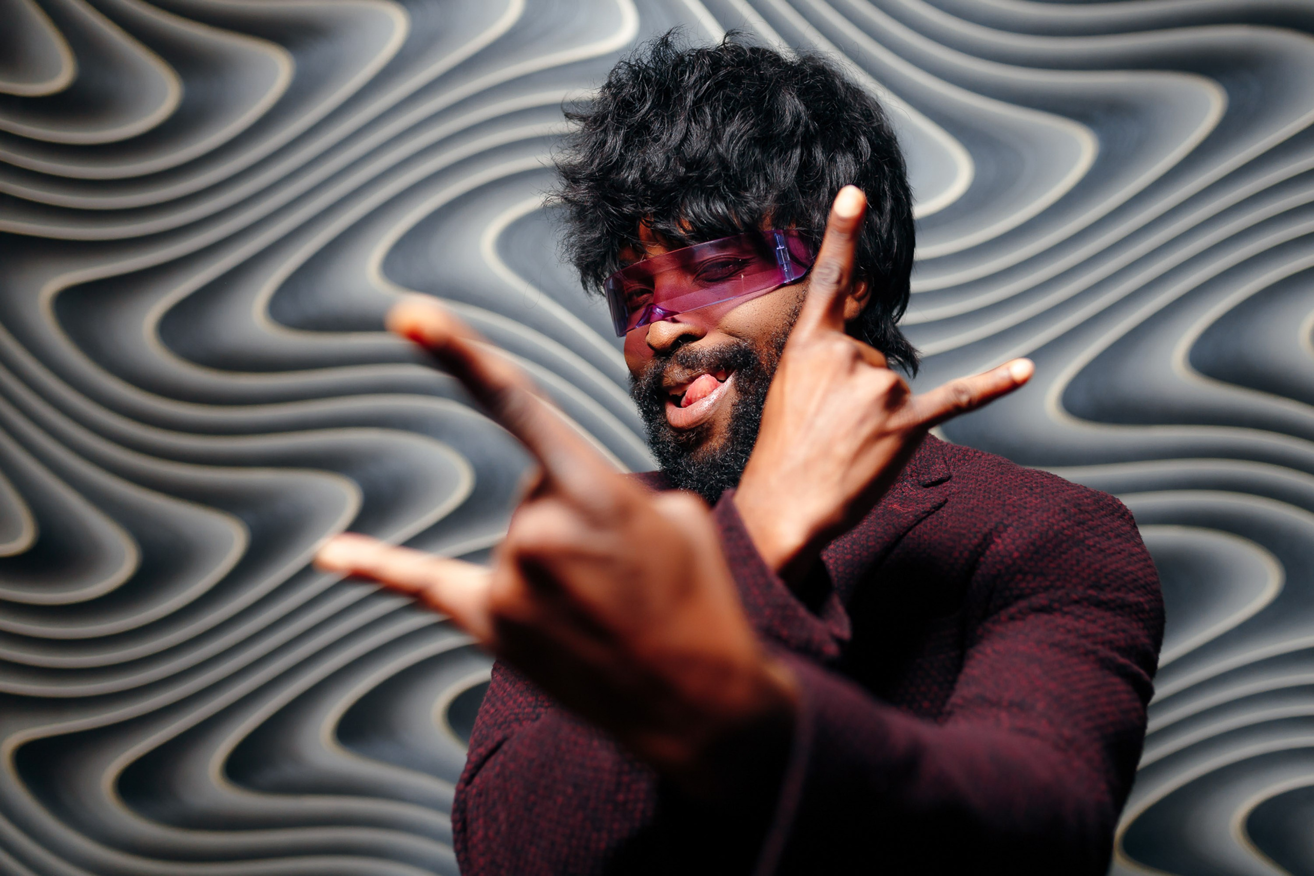 Man posing in front of artistic wall, creative portrait