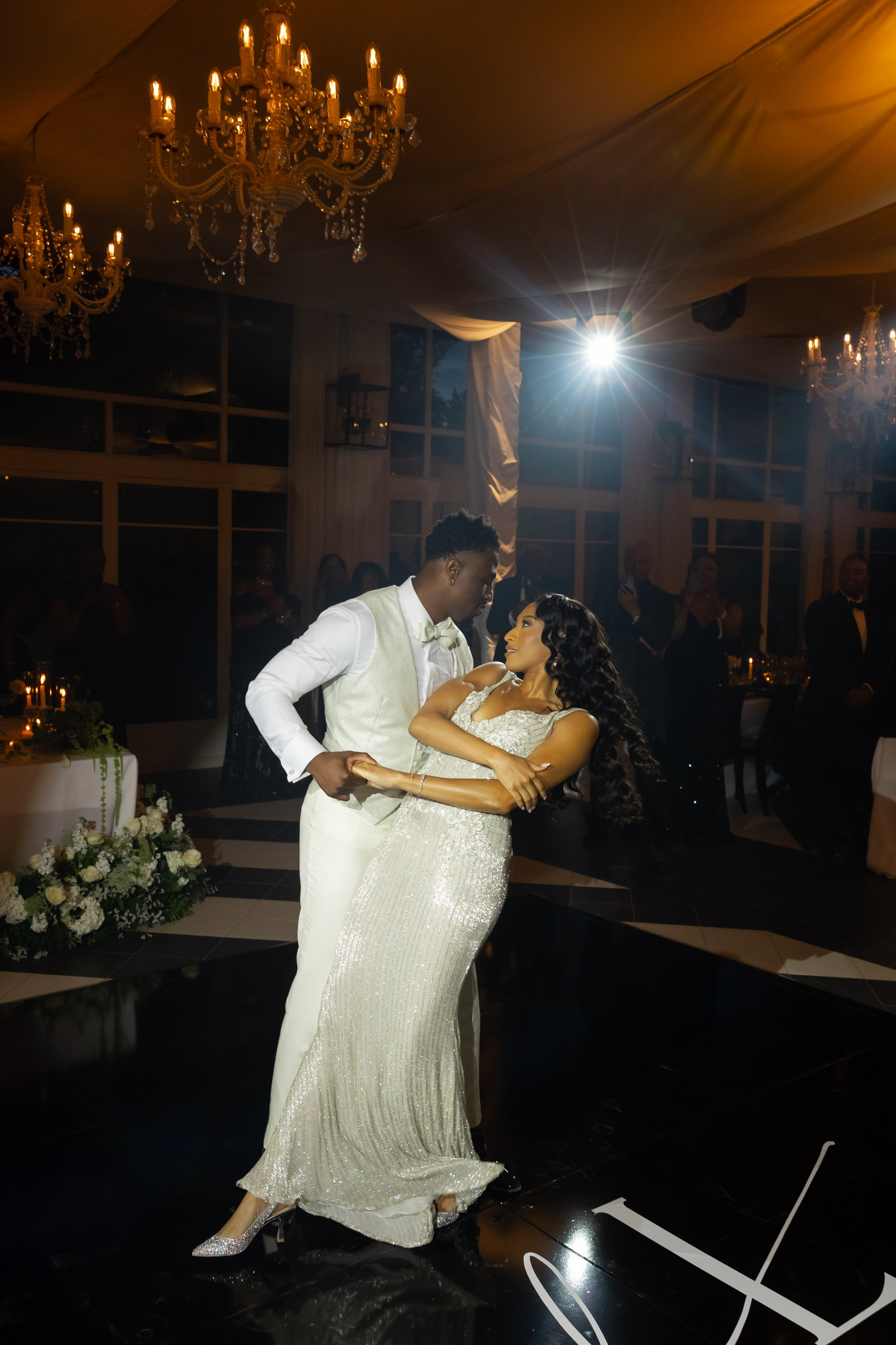 American dark skinned groom and bride dancing the first dance and looking at each other
