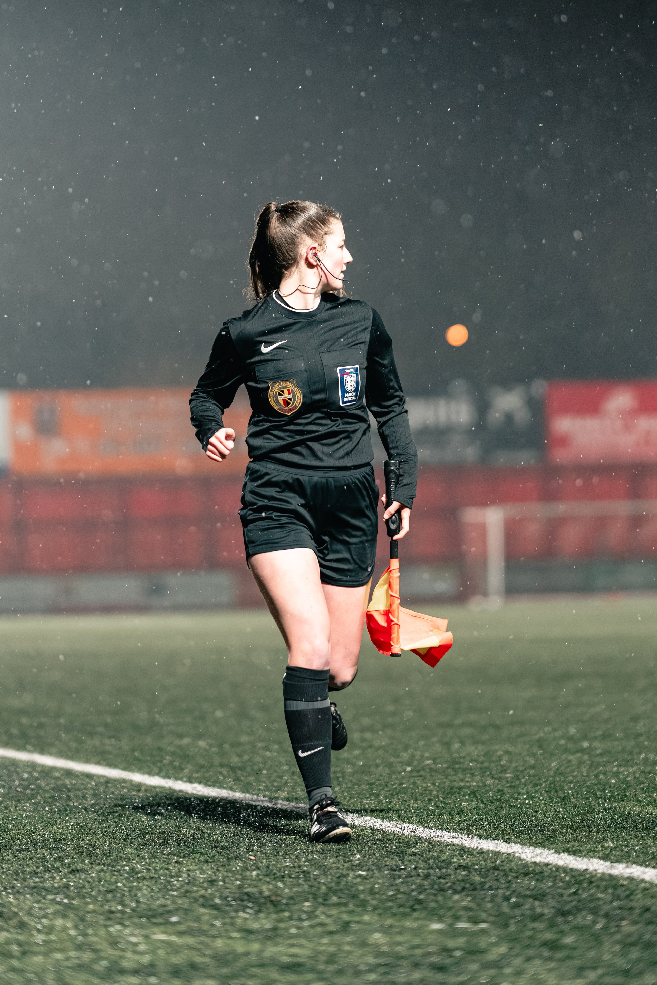 Assistant referee Julia Kings runs along the touchline holding a flag during the Birmingham Senior Cup match between Tamworth FC and Alvechurch at The Lamb Ground in Tamworth, Feb 3 2026.