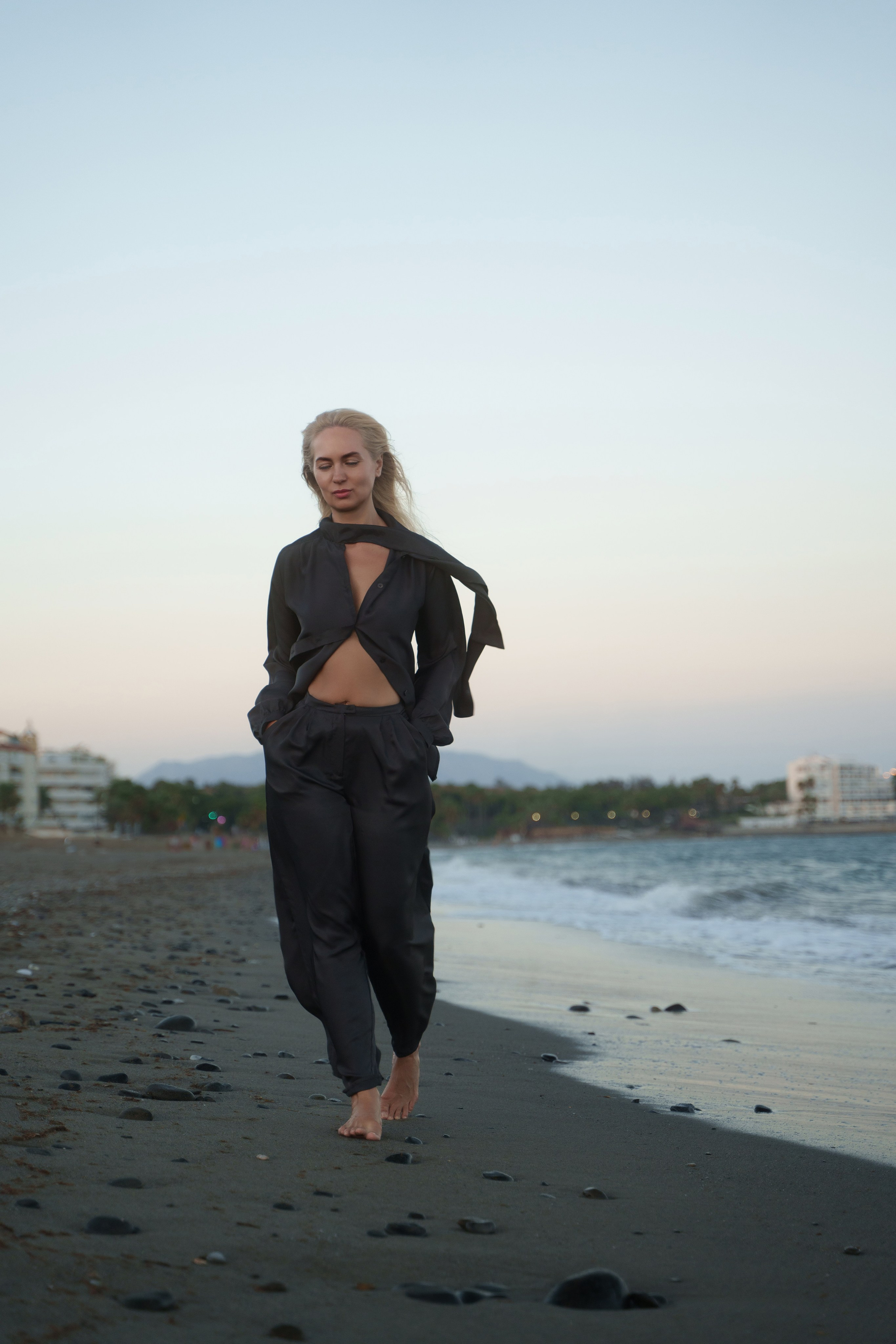 Chic blonde model posing by the waves on Estepona beach