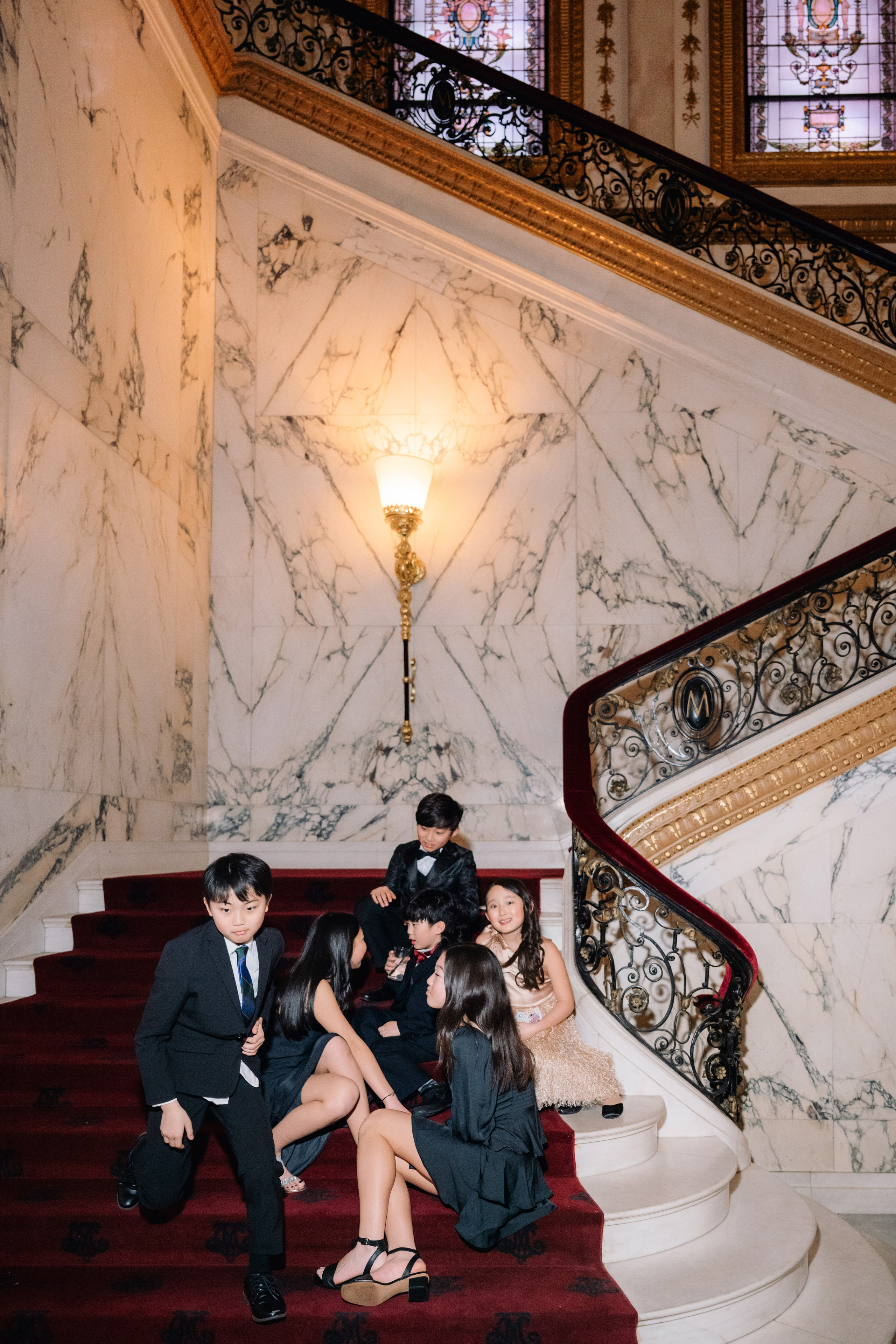 a couple sitting on a red carpet