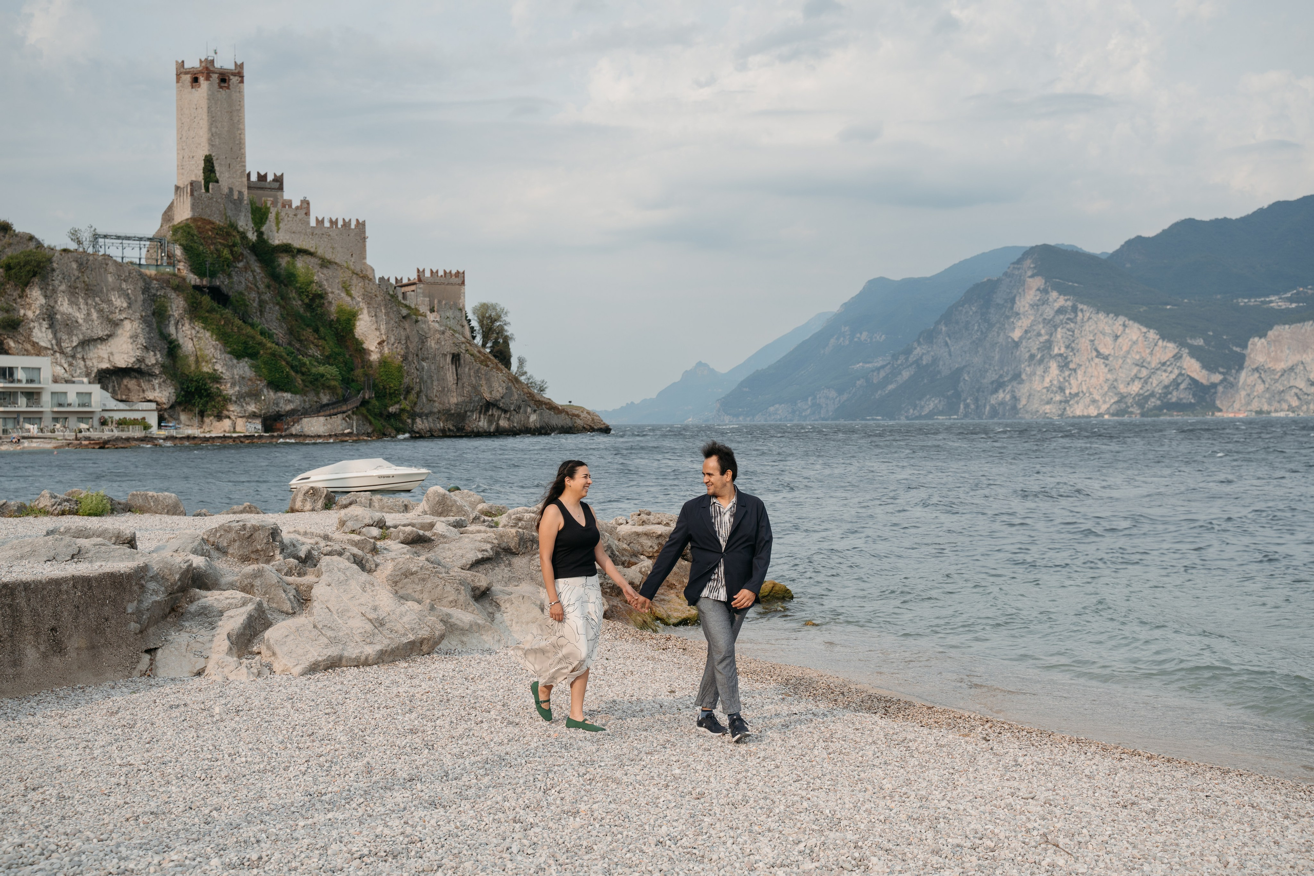 Romantic proposal photographer capturing a surprise engagement in Malcesine at sunrise.