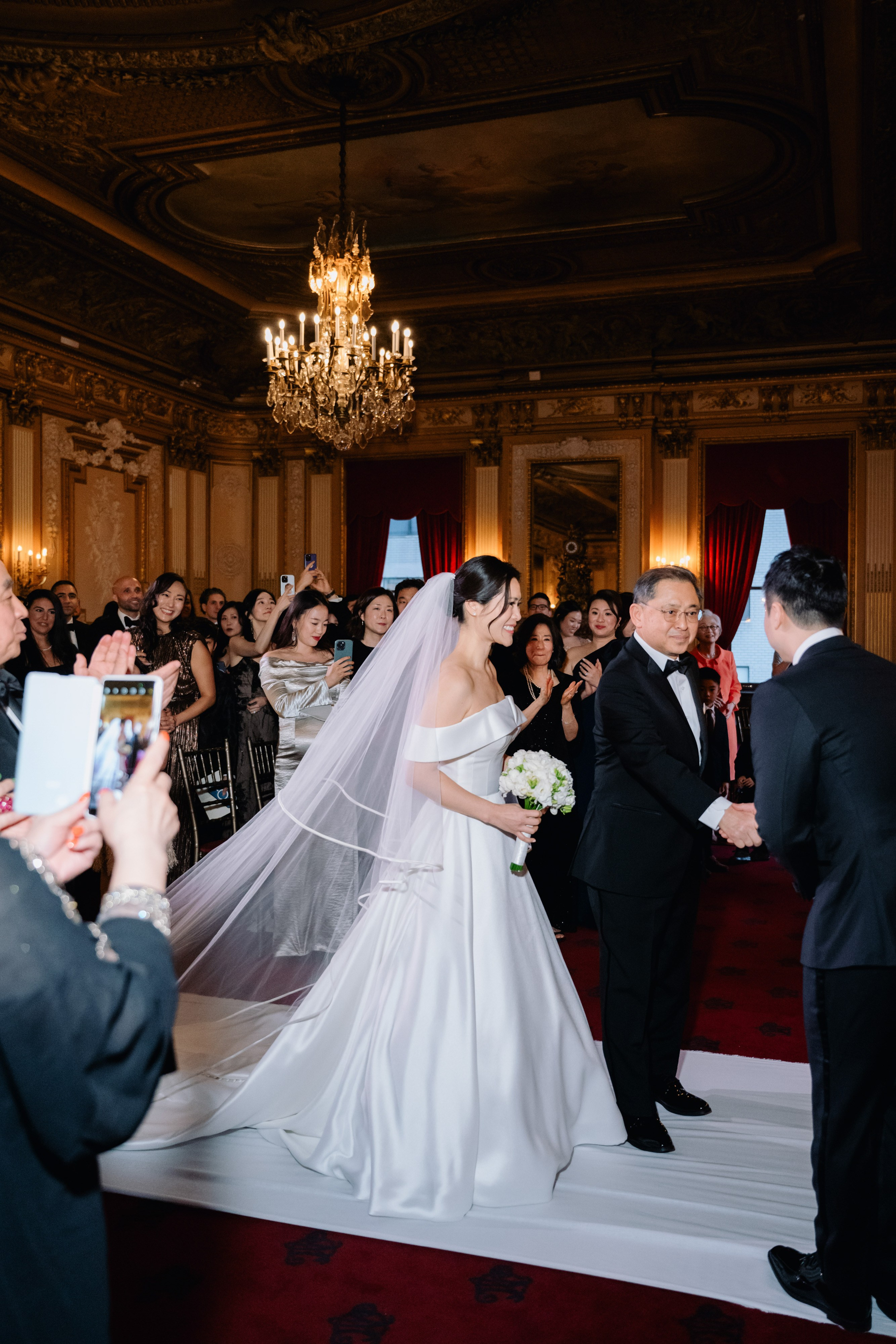 a bride and groom are walking down the aisle