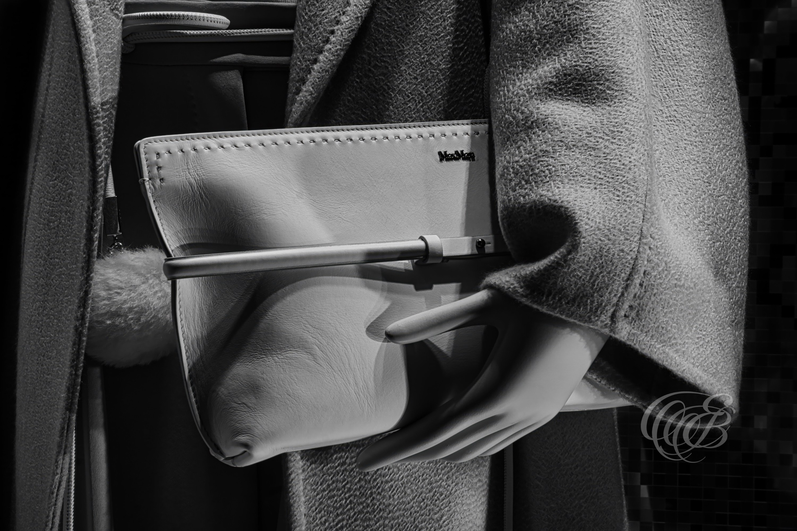 Rome Italy – Max Mara Bag - up close - Window Display B&W – Eduardo Bartoli Fine Art Photography - Black and white fine art photograph showing an up-close view of a mannequin’s hand holding a bag in the Max Mara window display in Rome, Italy – photography by Eduardo Bartoli.