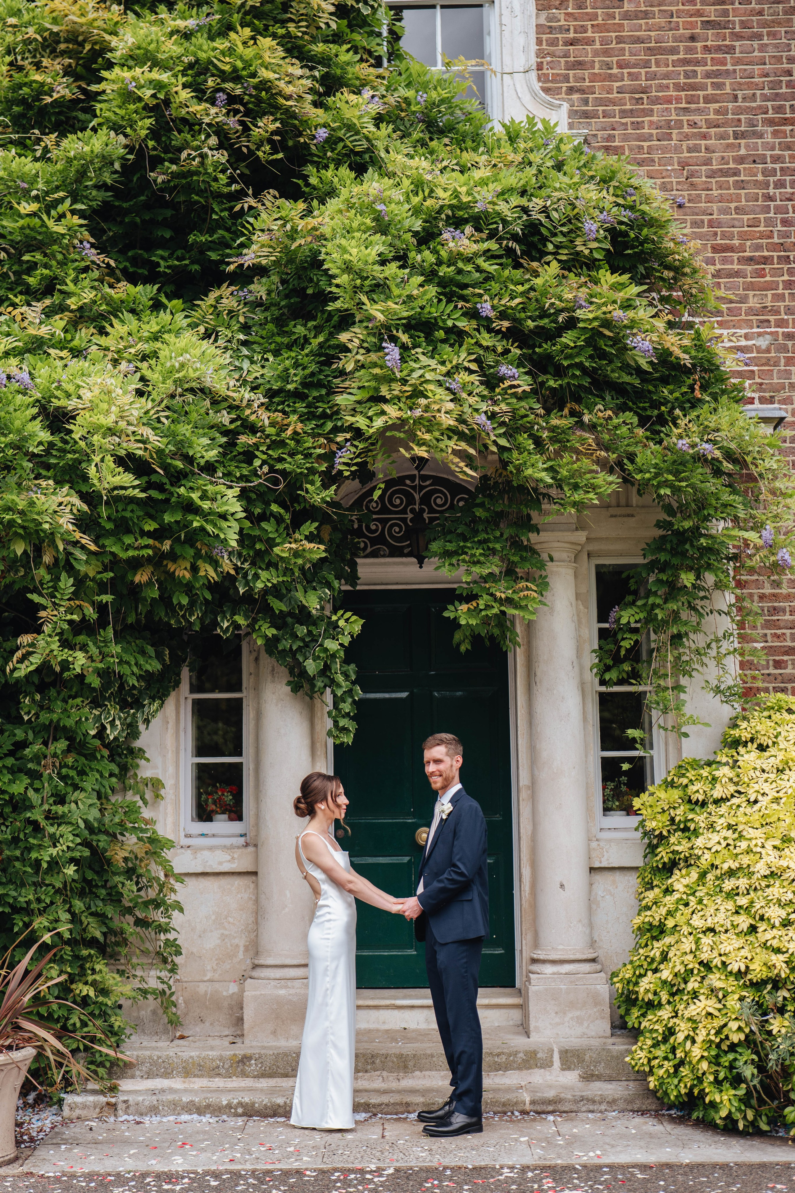 bride and groom holding hands and looking at each other