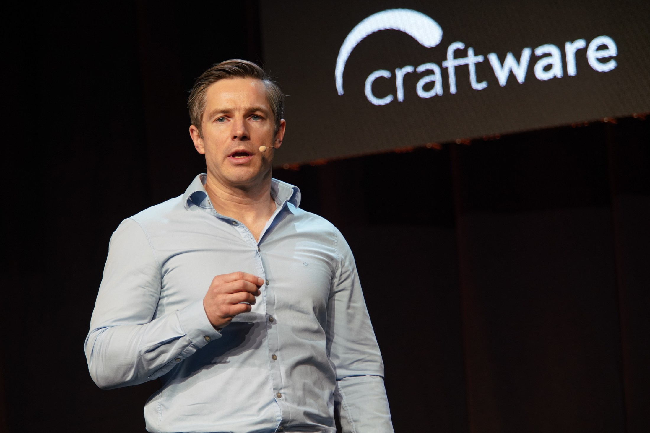 Jacek Zawlocki, CEO of Craftware, presents partnership highlights on stage. 