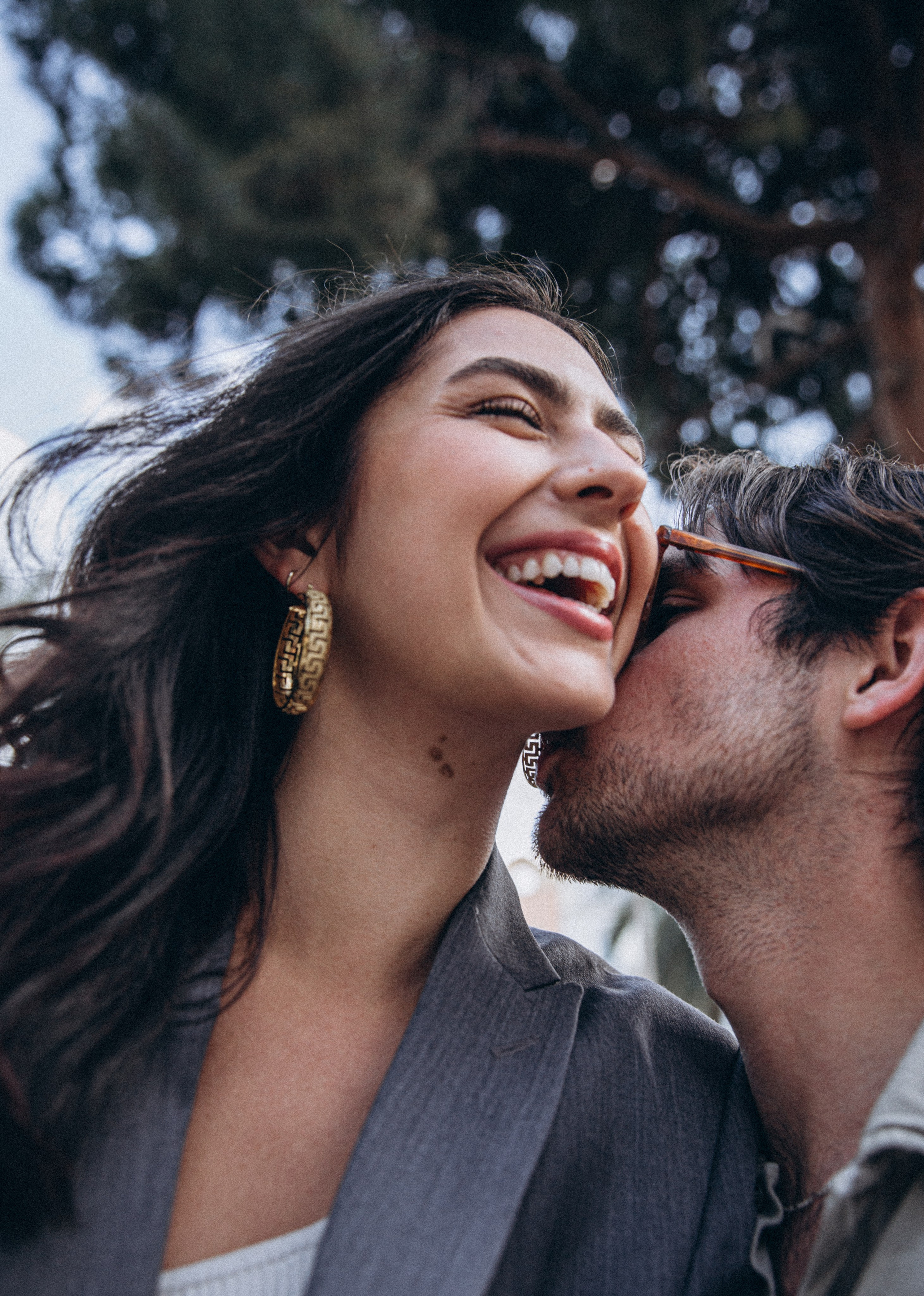 Playful couple sharing a joyful moment in Madrid, Spain — candid love story photoshoot capturing laughter, intimacy, and authentic connection, perfect for couples seeking natural and emotional photography sessions in Madrid and across Spain.