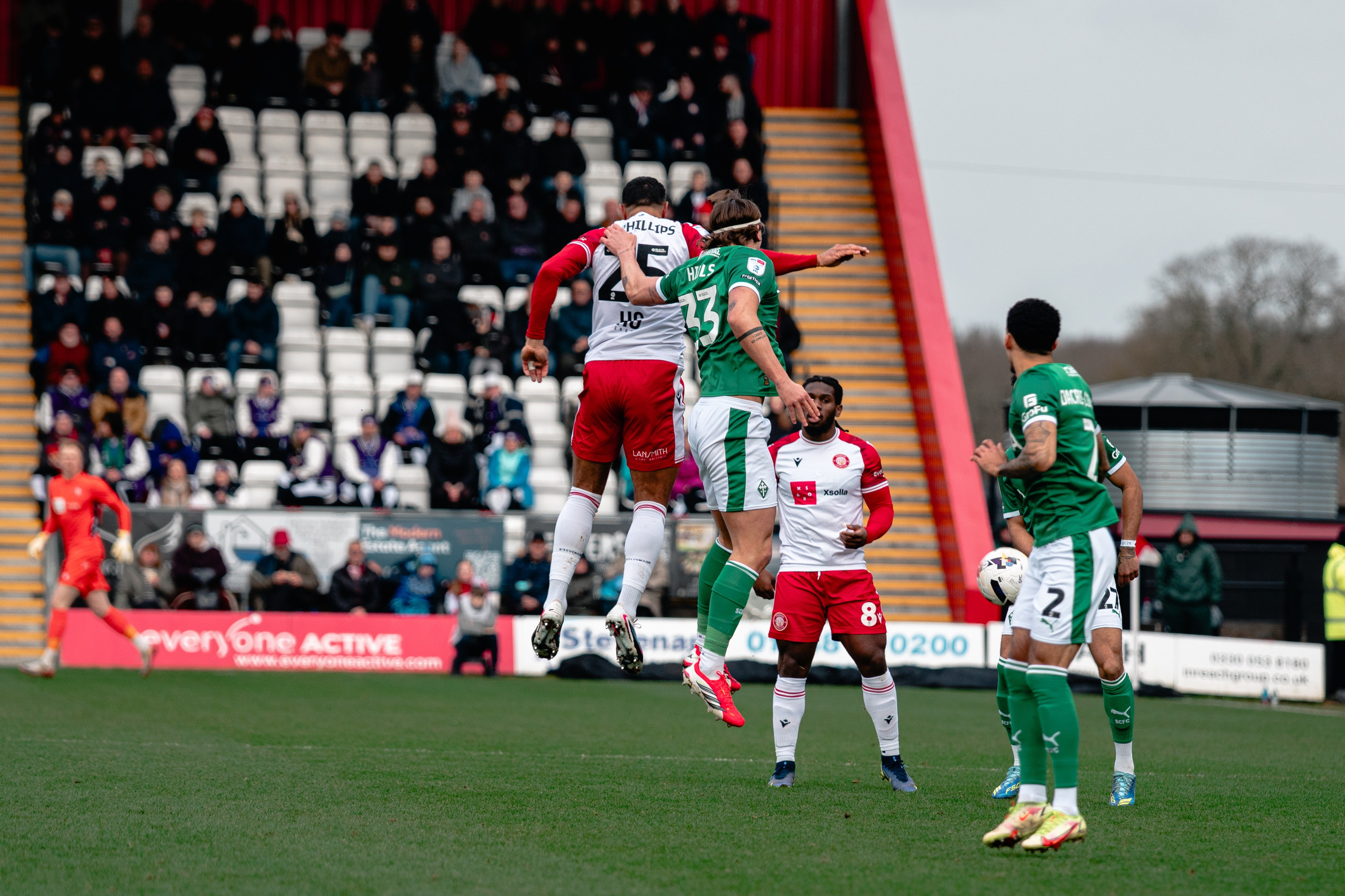 Stevenage and Stockport County players competing for an aerial ball during their League One fixture.