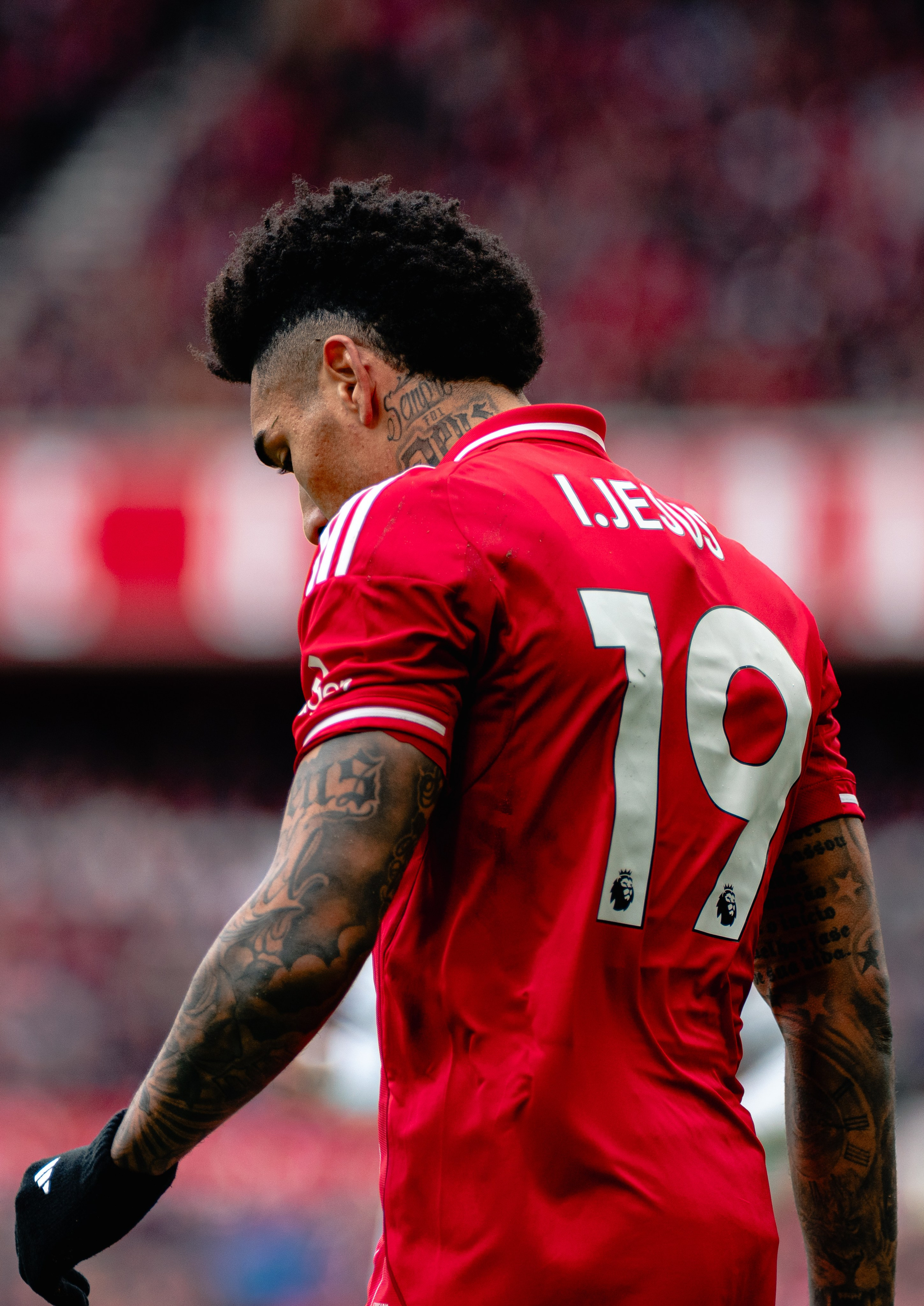 Football player Igor Jesus wearing number 19 in a red kit walking during a professional match