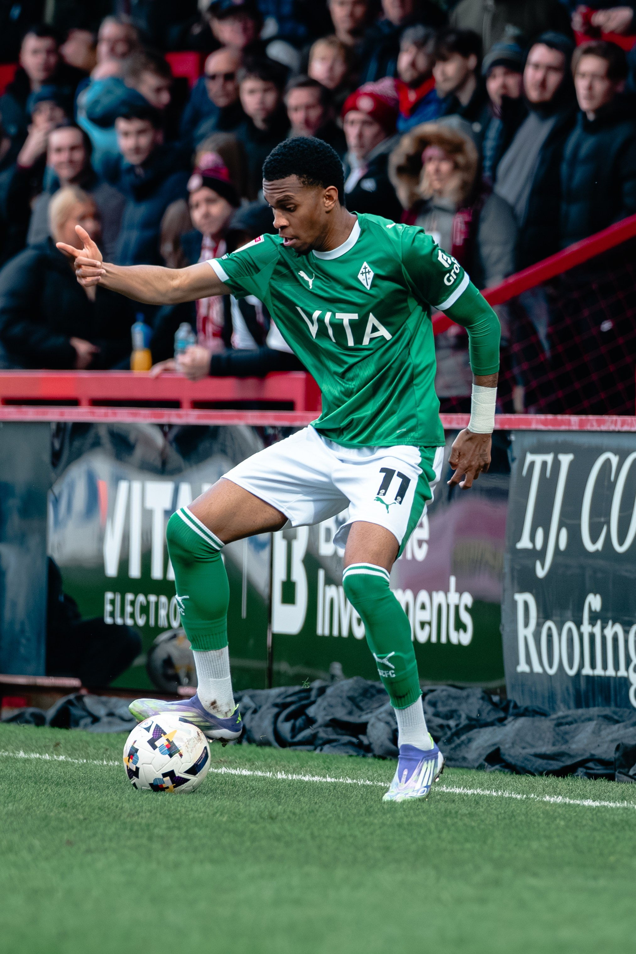 Stockport County player controlling the ball near the touchline during the League One match against Stevenage.