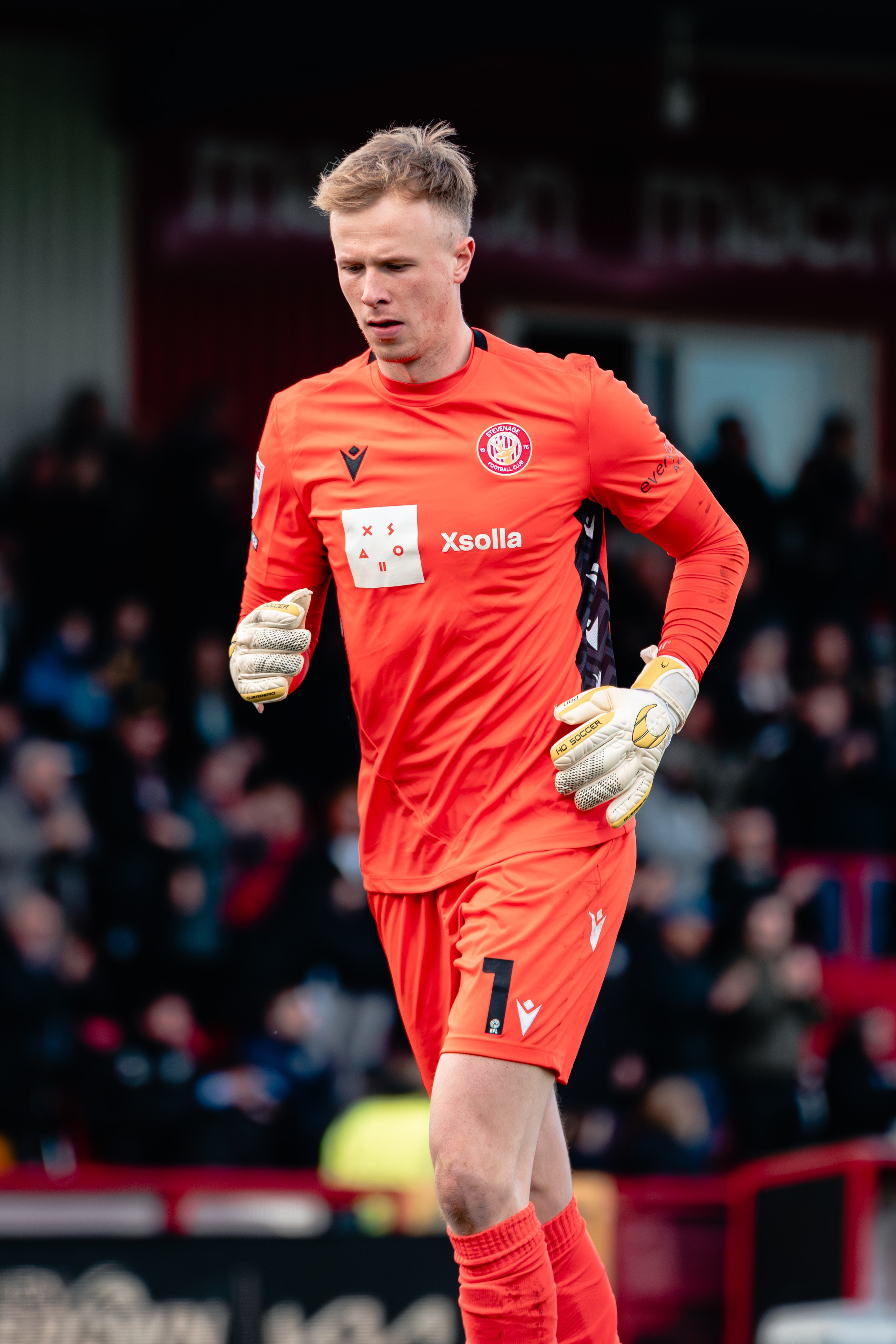 Stevenage goalkeeper in an orange kit during the League One fixture against Stockport County.