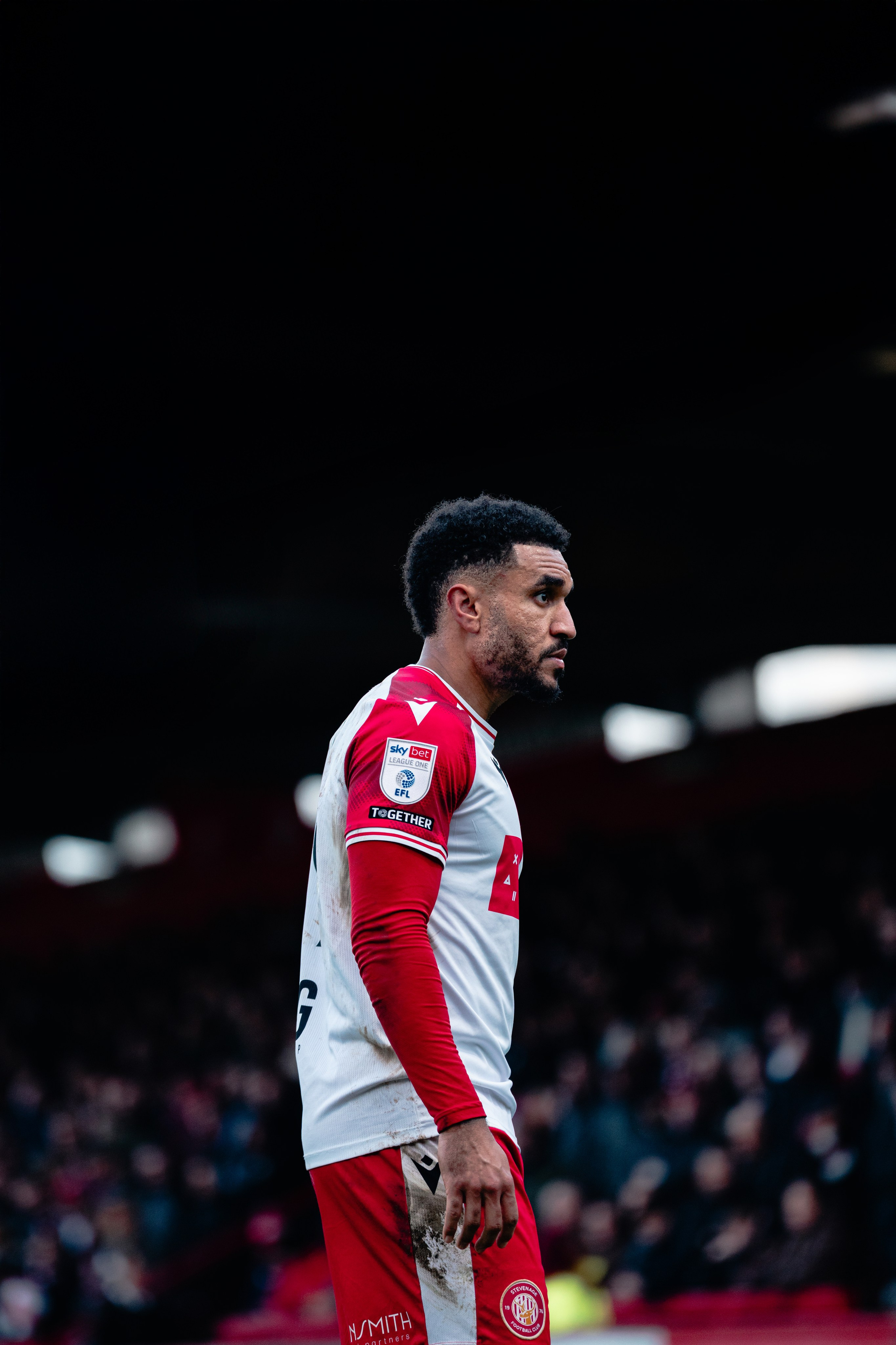Stevenage player in the red and white home kit during the League One match against Stockport County at the Lamex Stadium.