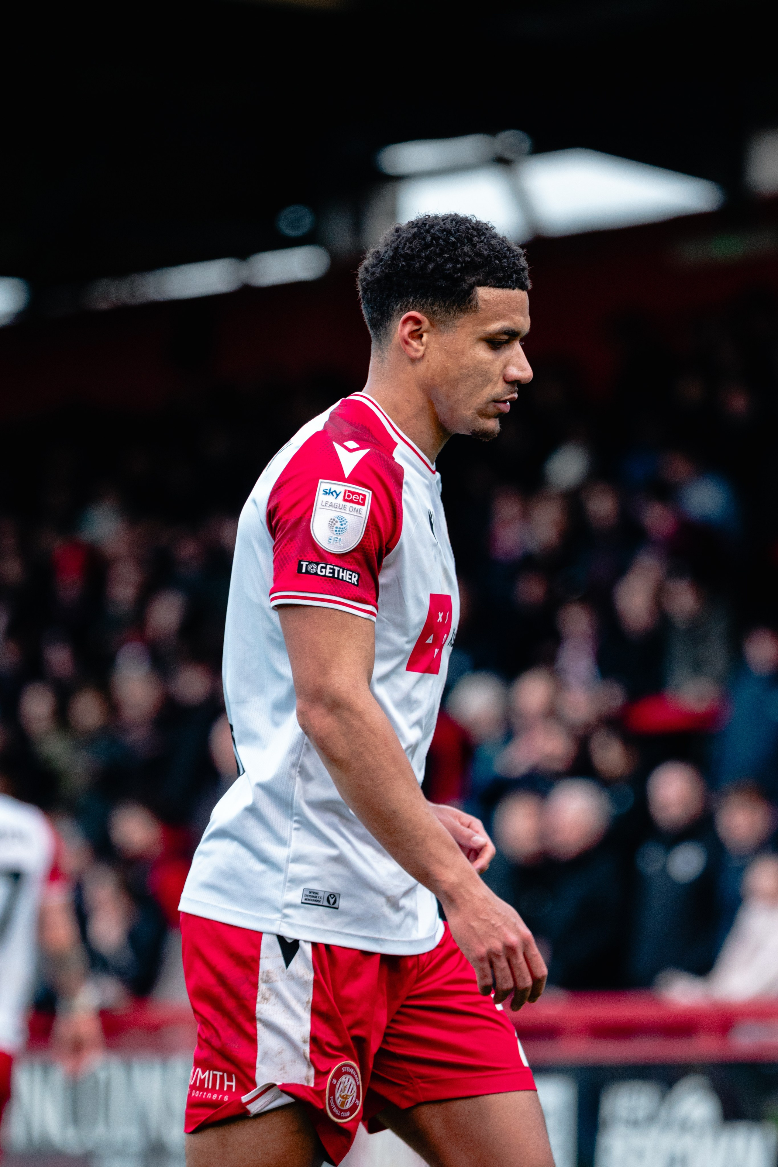 Stevenage player in the red and white home kit during the League One match against Stockport County.