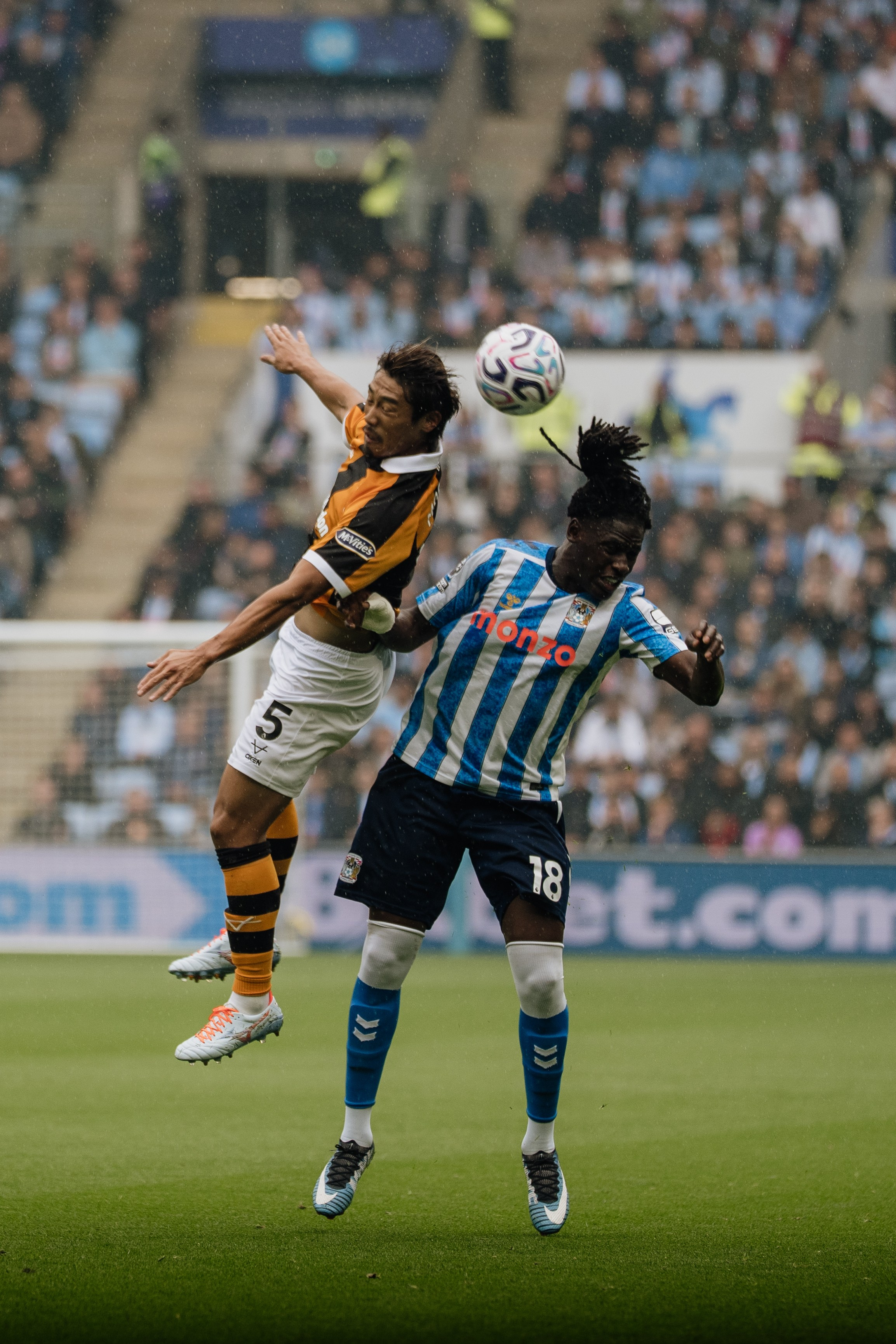 Coventry City and Hull City players competing for an aerial ball during their Premier League fixture