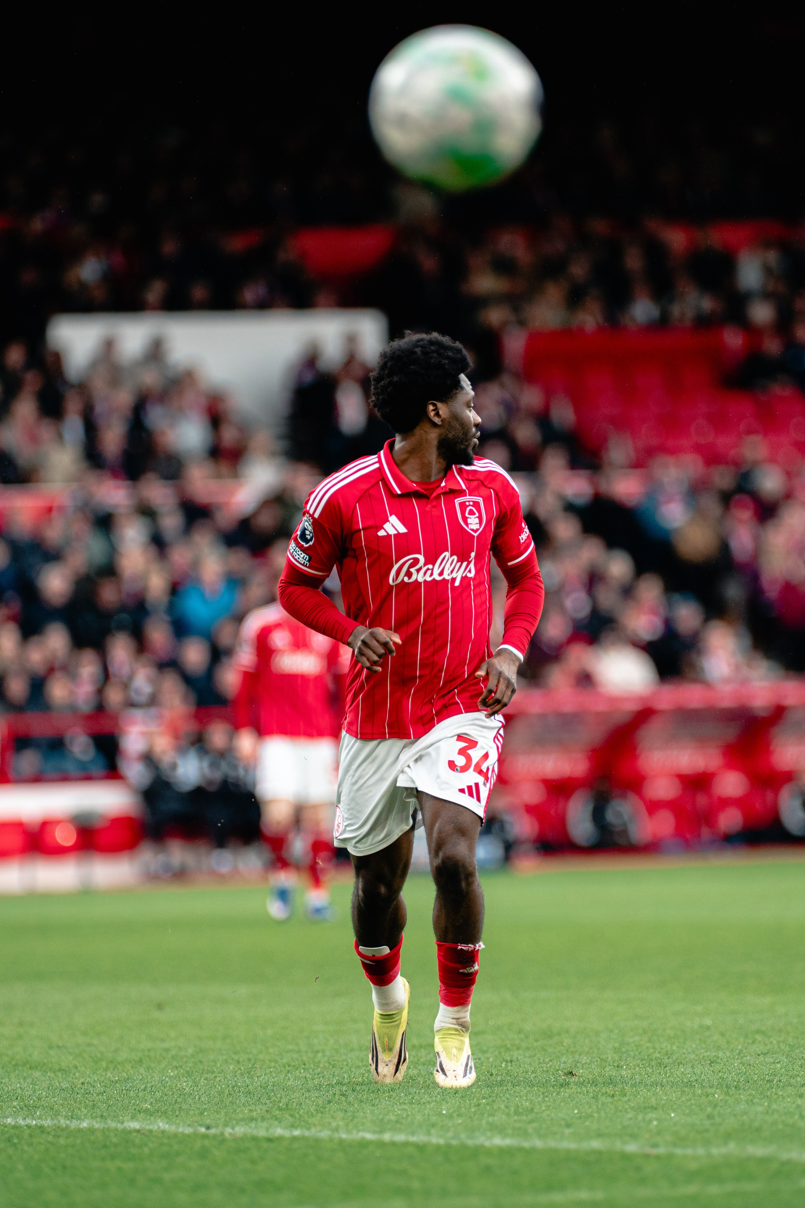 Nottingham Forest player controlling the ball during a professional football match at the City Ground.