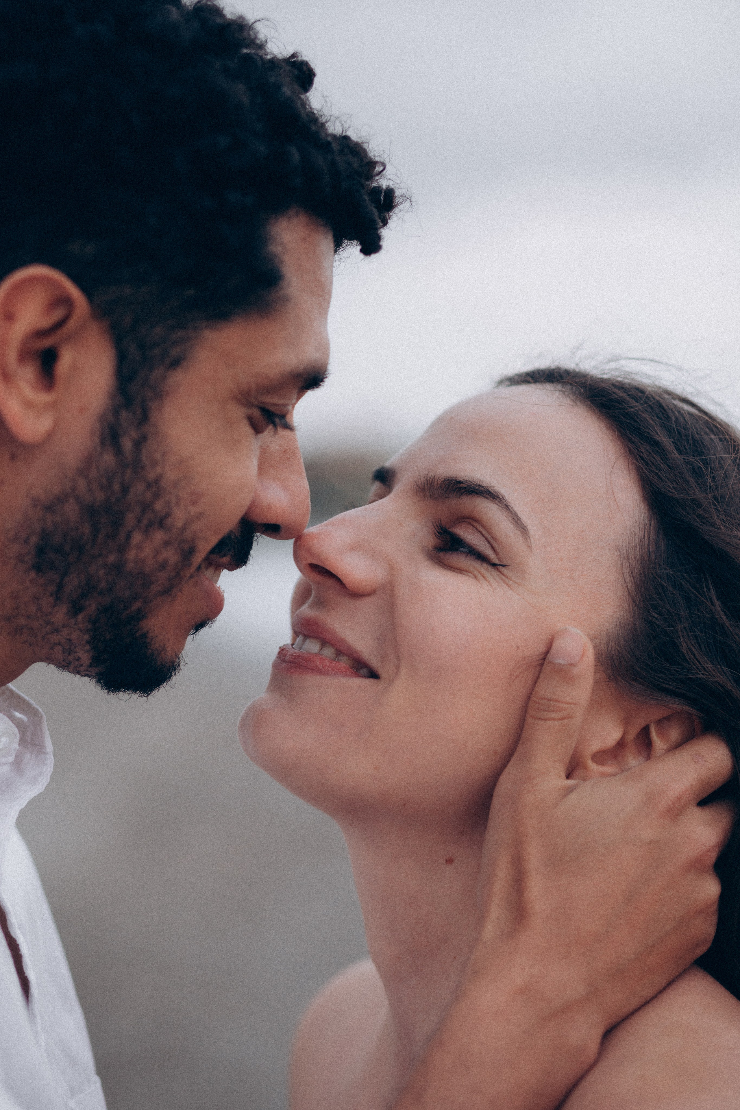 Close-up romantic moment of a couple gently touching noses and smiling in Madrid, Spain — intimate love story photography capturing emotional connection, tenderness, and authentic expressions, perfect for couple photoshoots in Madrid and Spain.